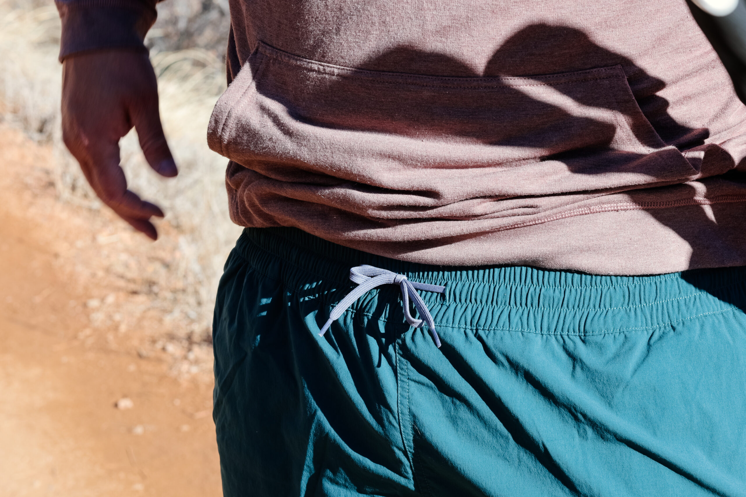 Close up of a drawstring on green shorts.