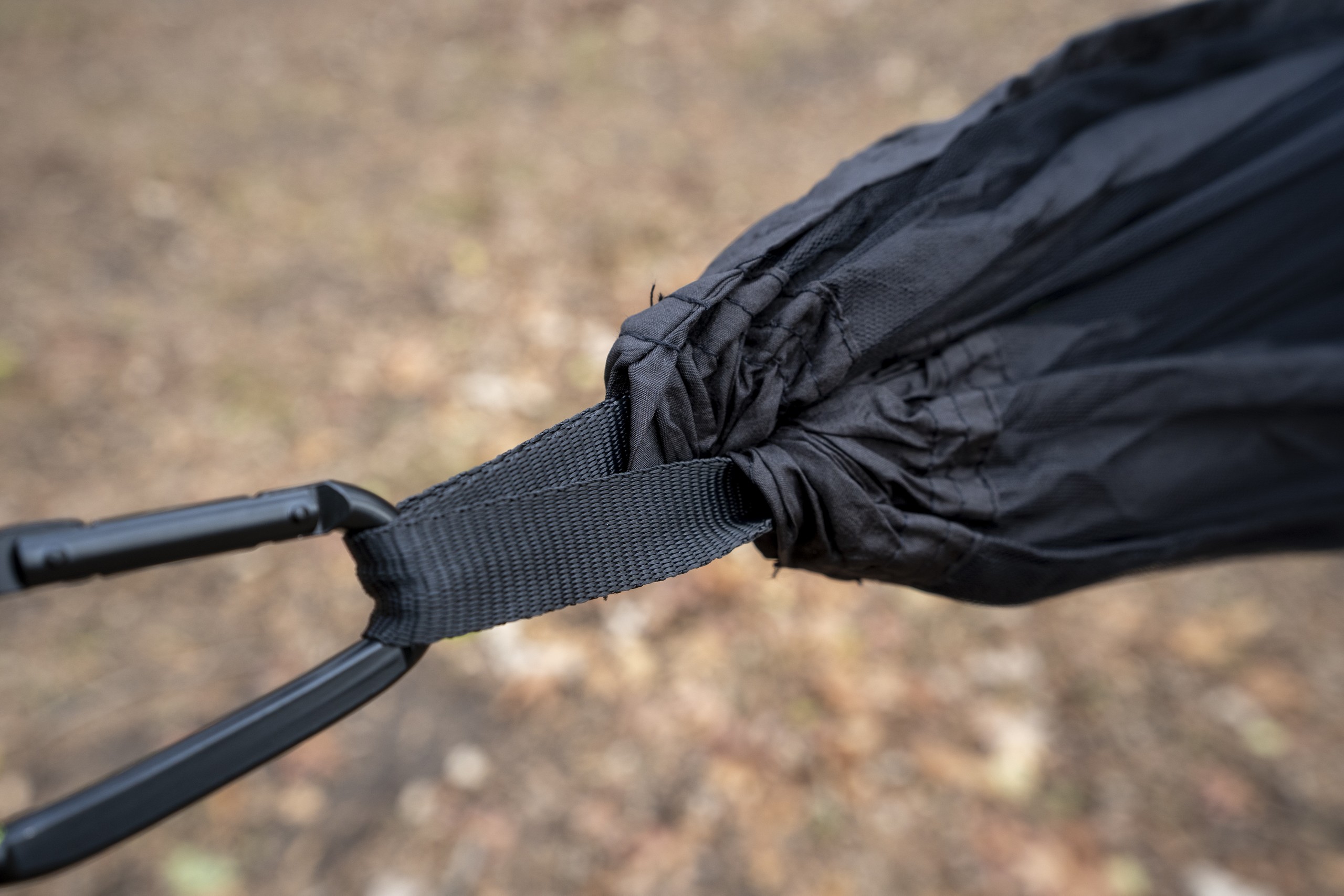 a carabiner attached to the end of a hammock