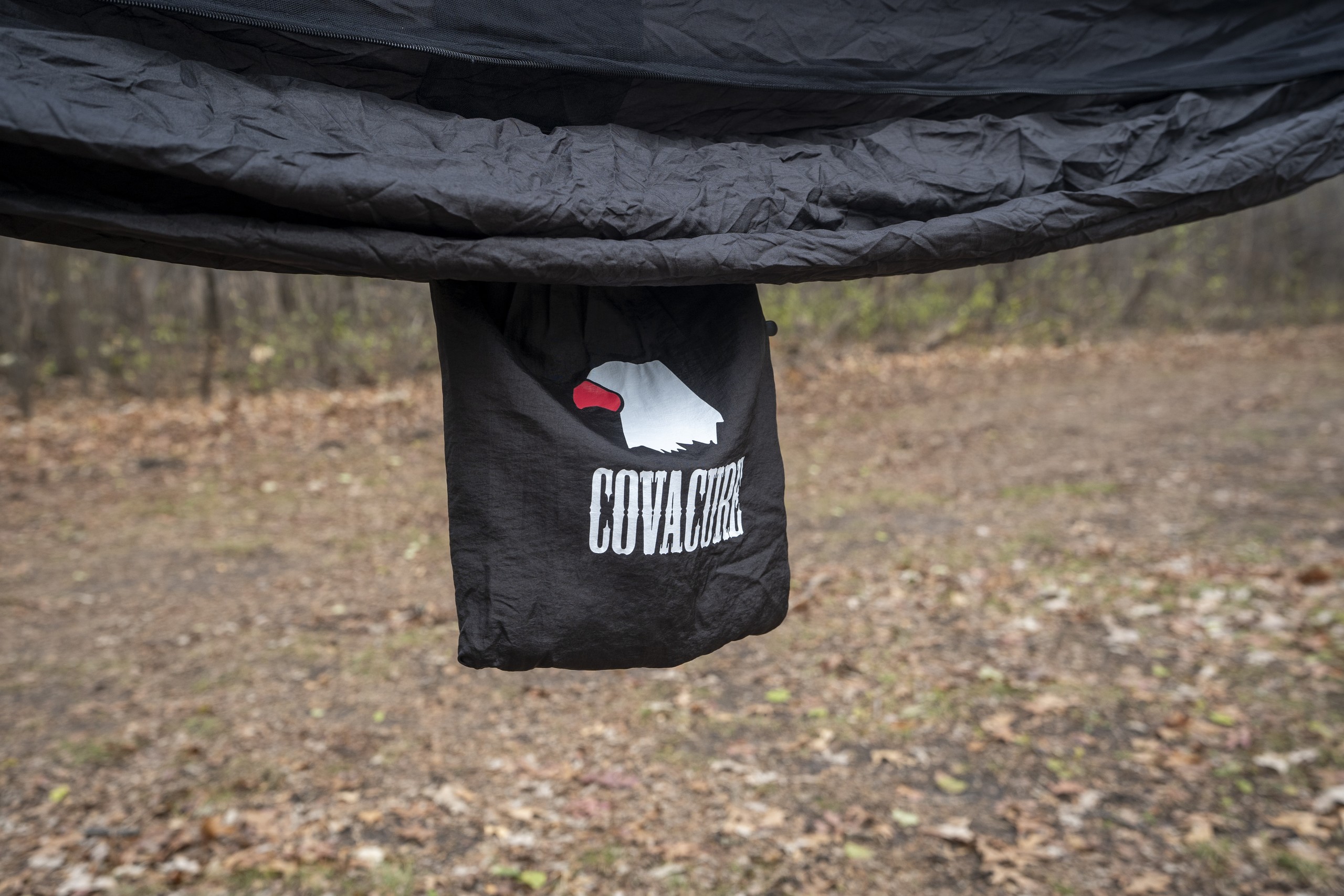 a storage bag hangs on the side of a hammock