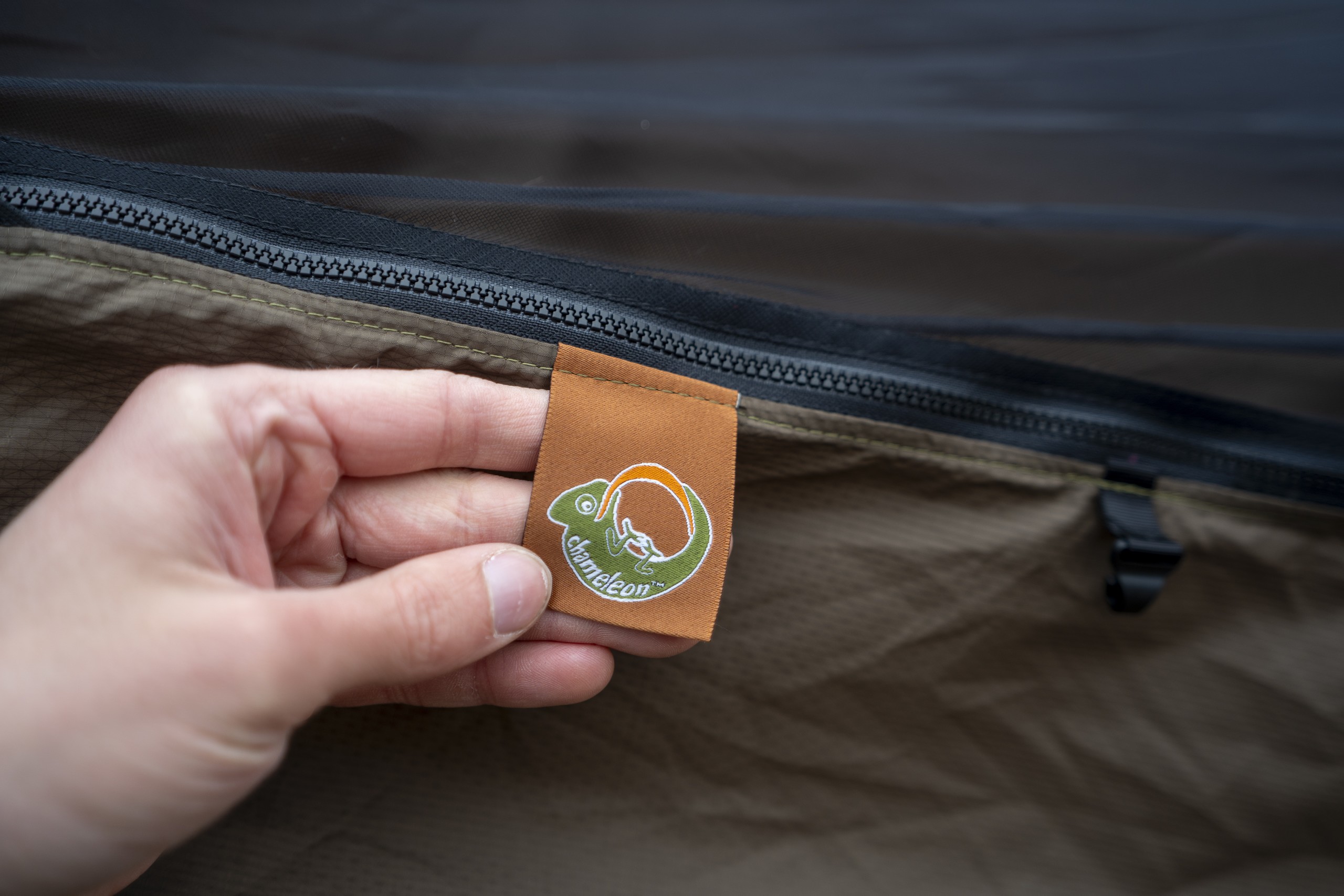 A hand holds a label on a hammock