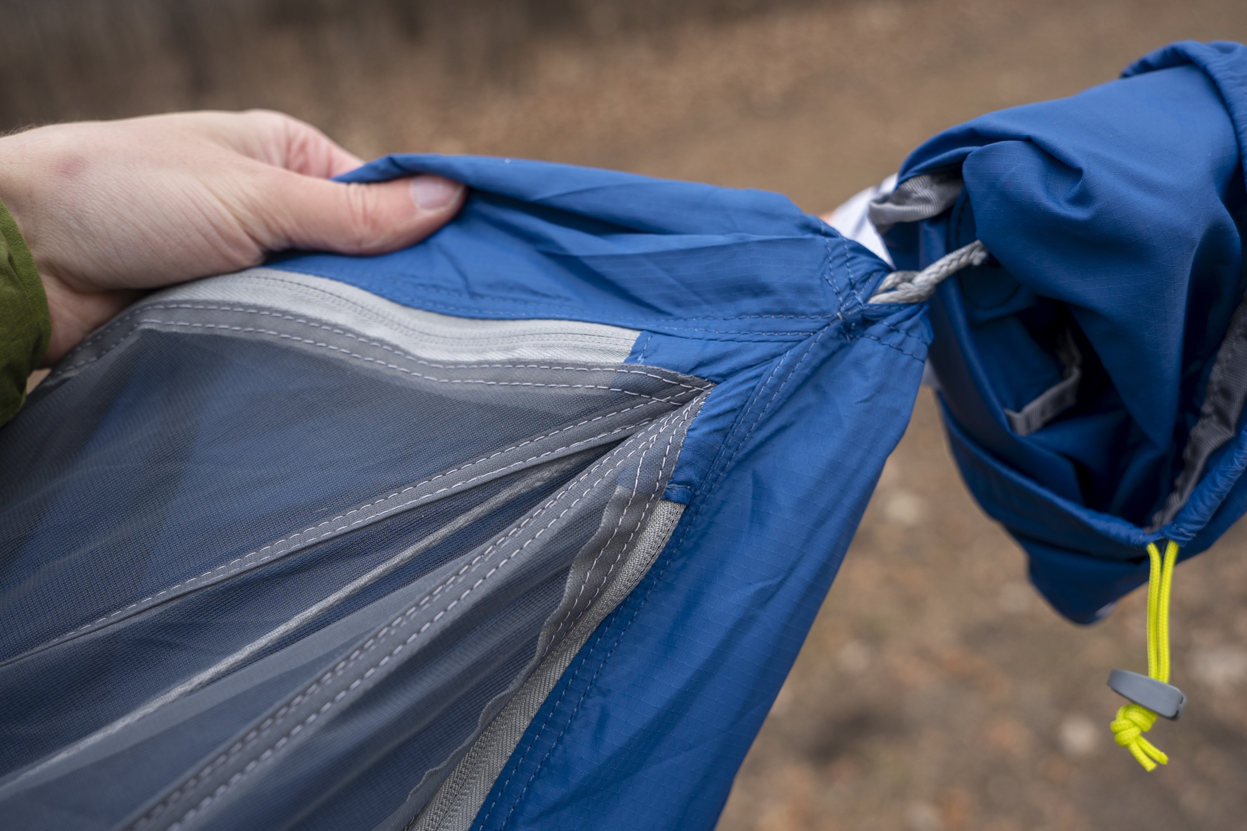 the end of a hammock showing the zippered bug net ends