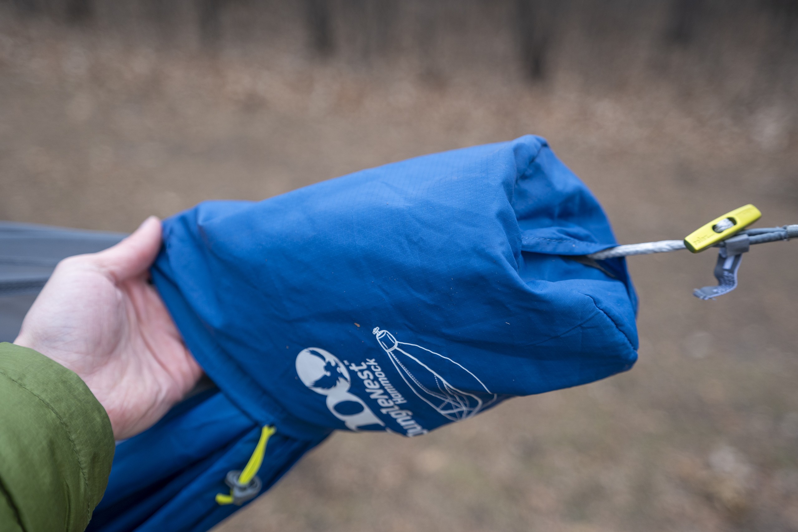 a bag hangs on the end of a hammock