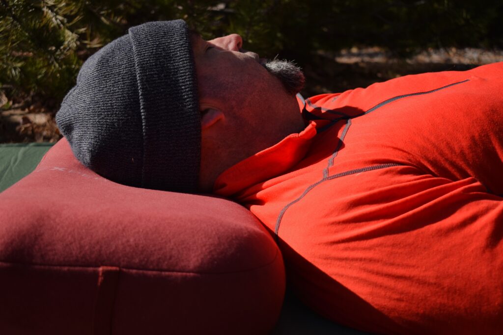 The author rests on the Exped Mega Pillow with a relaxed look on his face