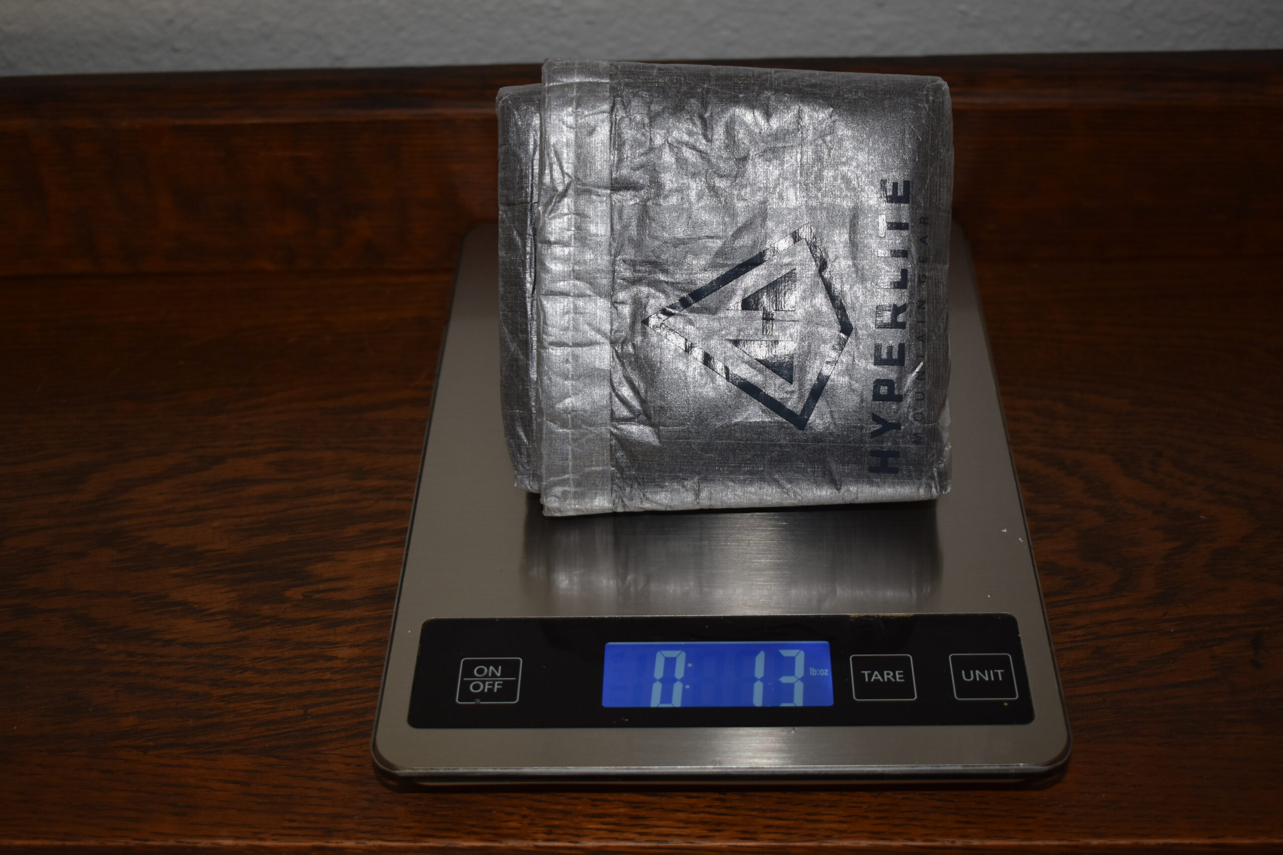 Hyperlite Stuff Sack Pillow sitting on a kitchen scale that reads 1.3 ounces