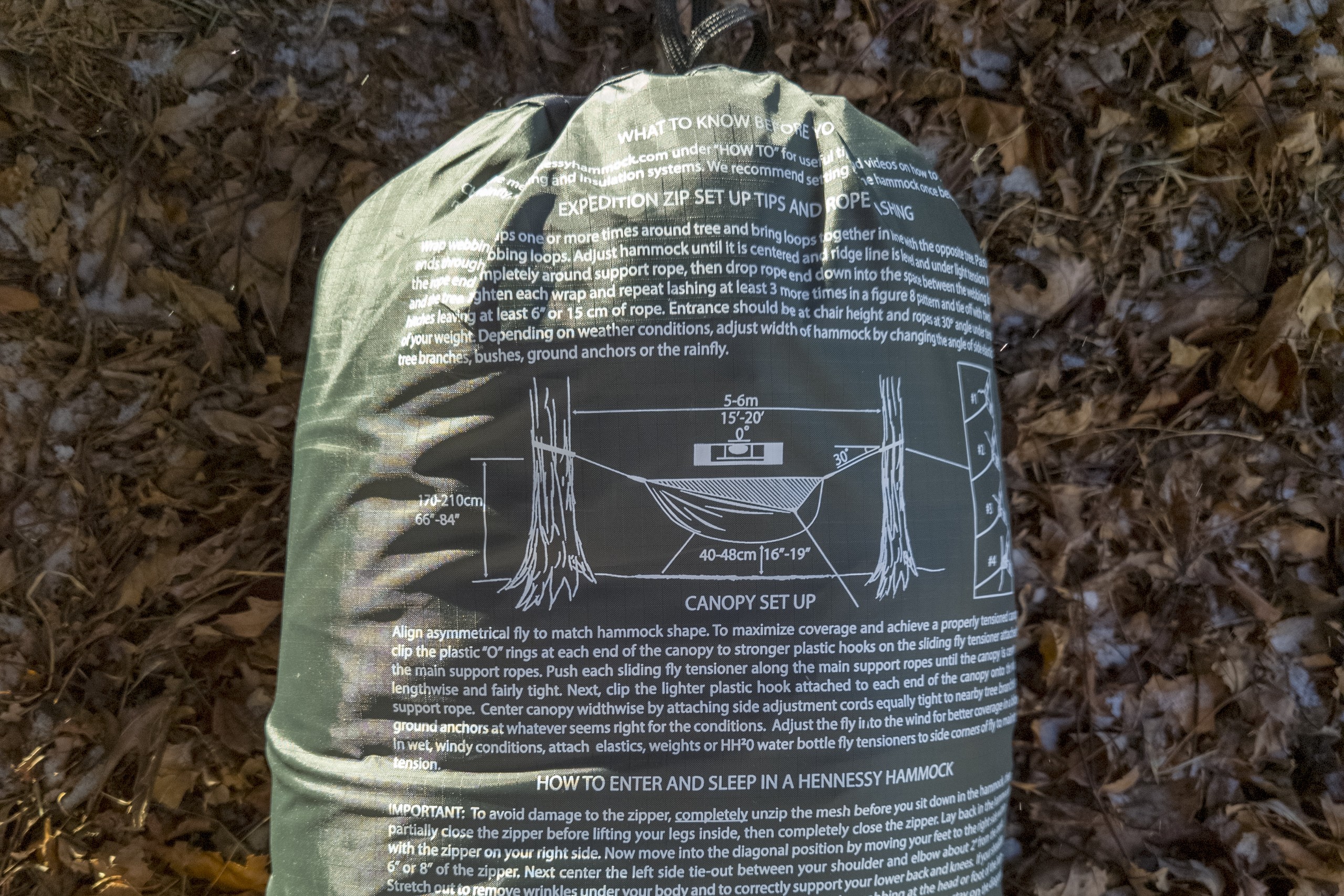 a hammock bag showing printed instructions on it for how to set up the hammock