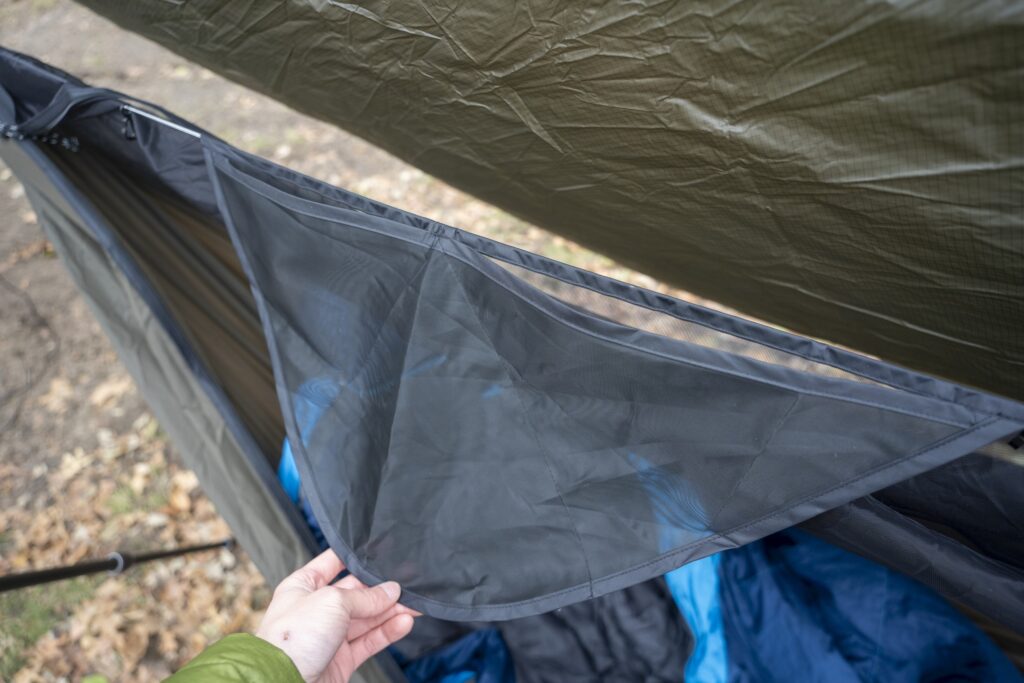 a hand holds a hammock ridgeline pocket