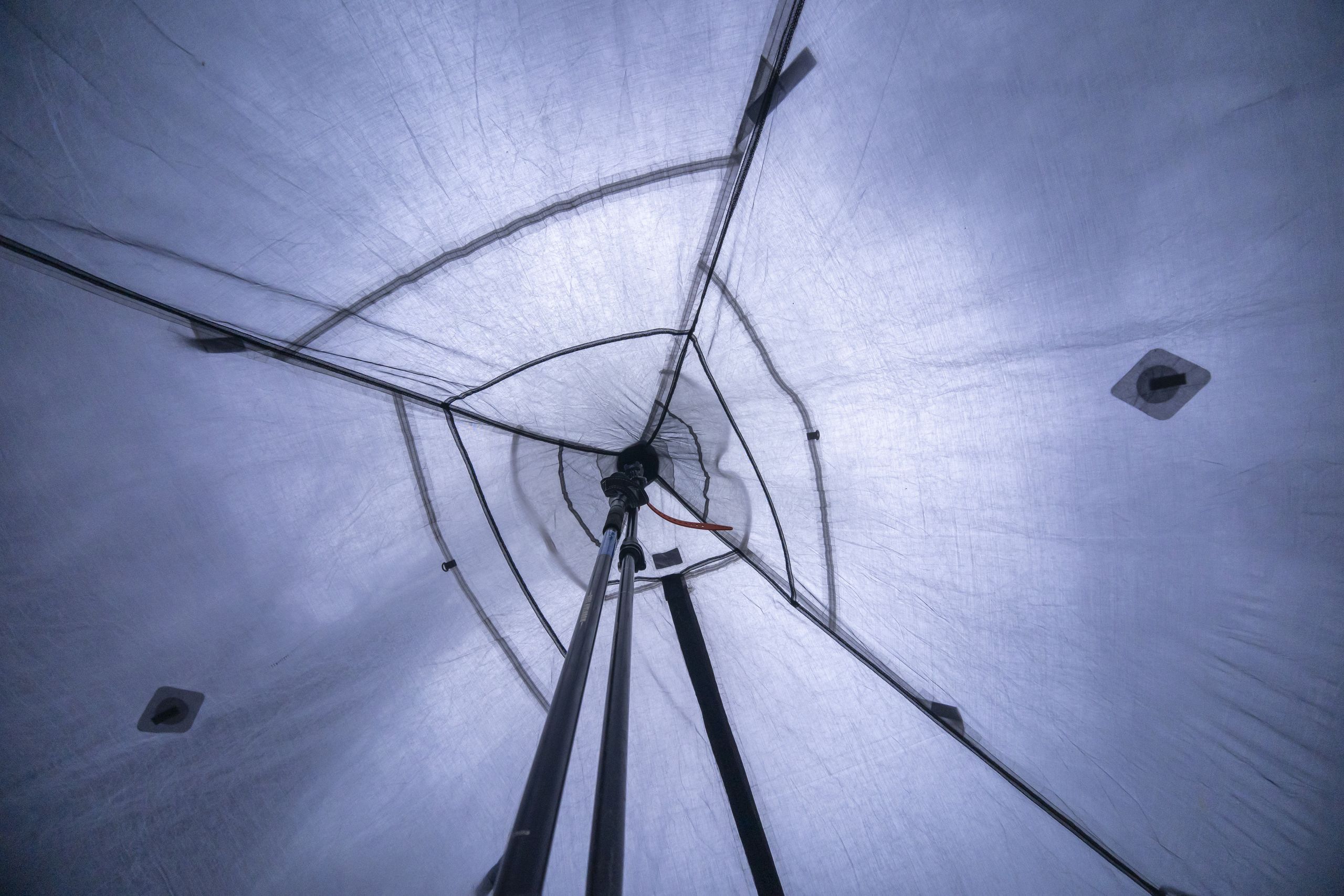 a view into the peak of a pyramid tent