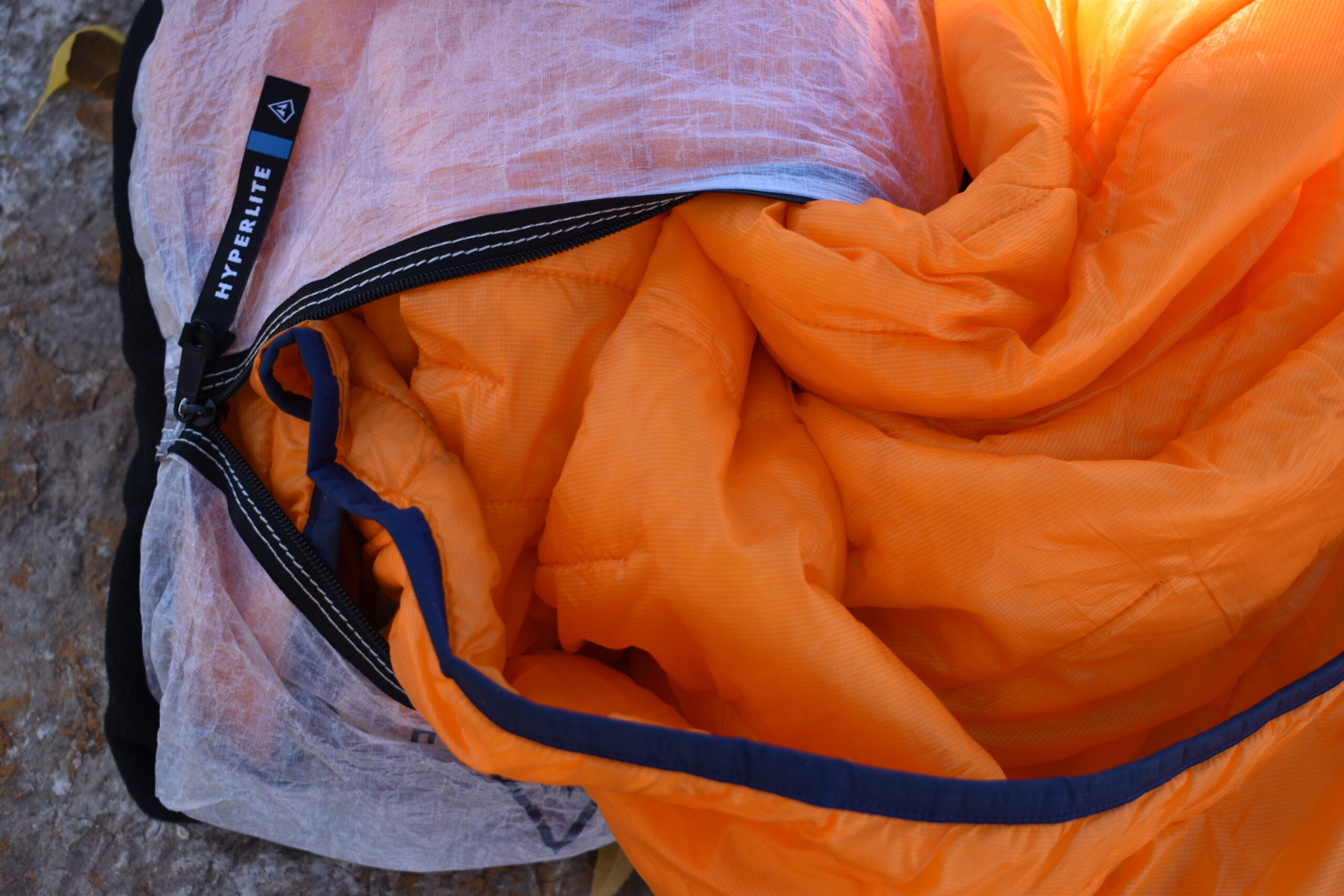 A bright puffy jacket is partially stuffed inside the Hyperlite Stuff Sack Pillow