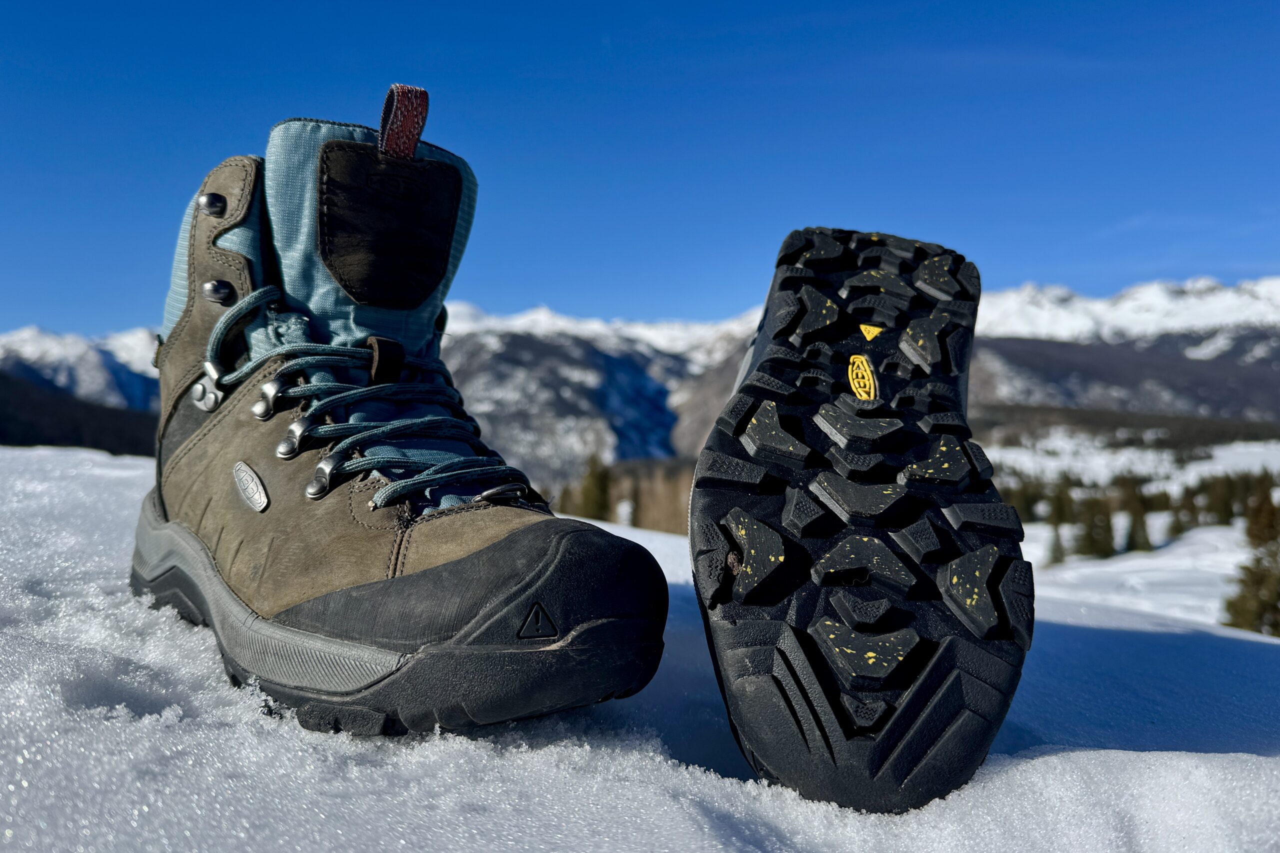 A close up of the tread on the bottom of the Keen boot. It is sitting in the snow in the mountains.