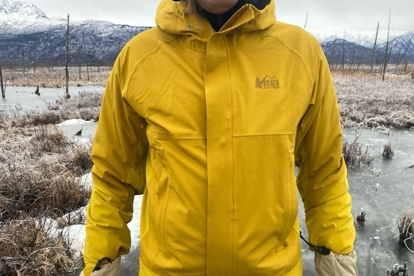 A closeup of the front of a yellow rain jacket.