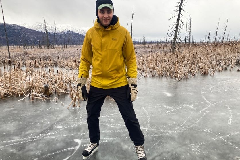 A man hockey skates wearing winter gloves