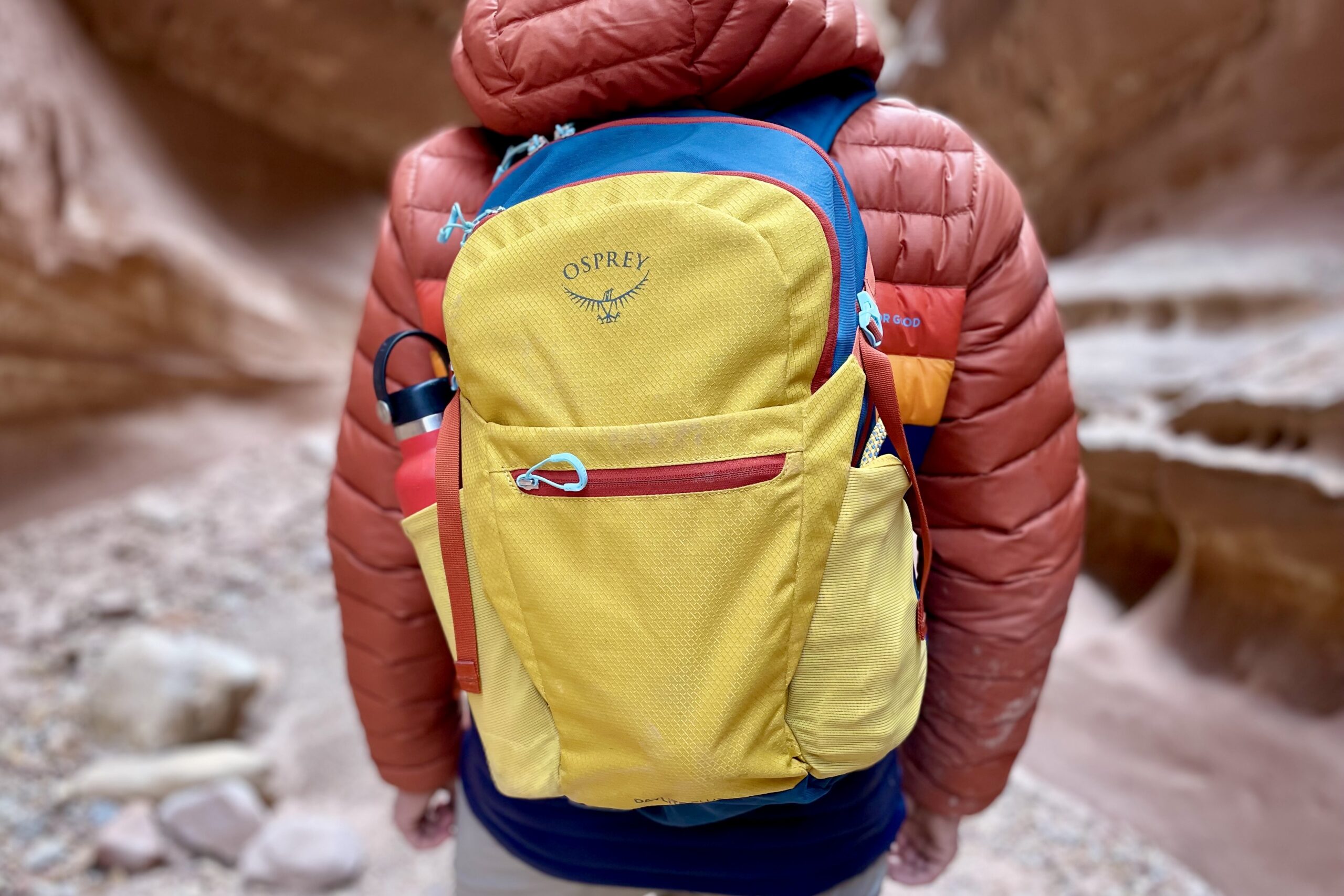 Close up of a backpack on a person's back in the desert.