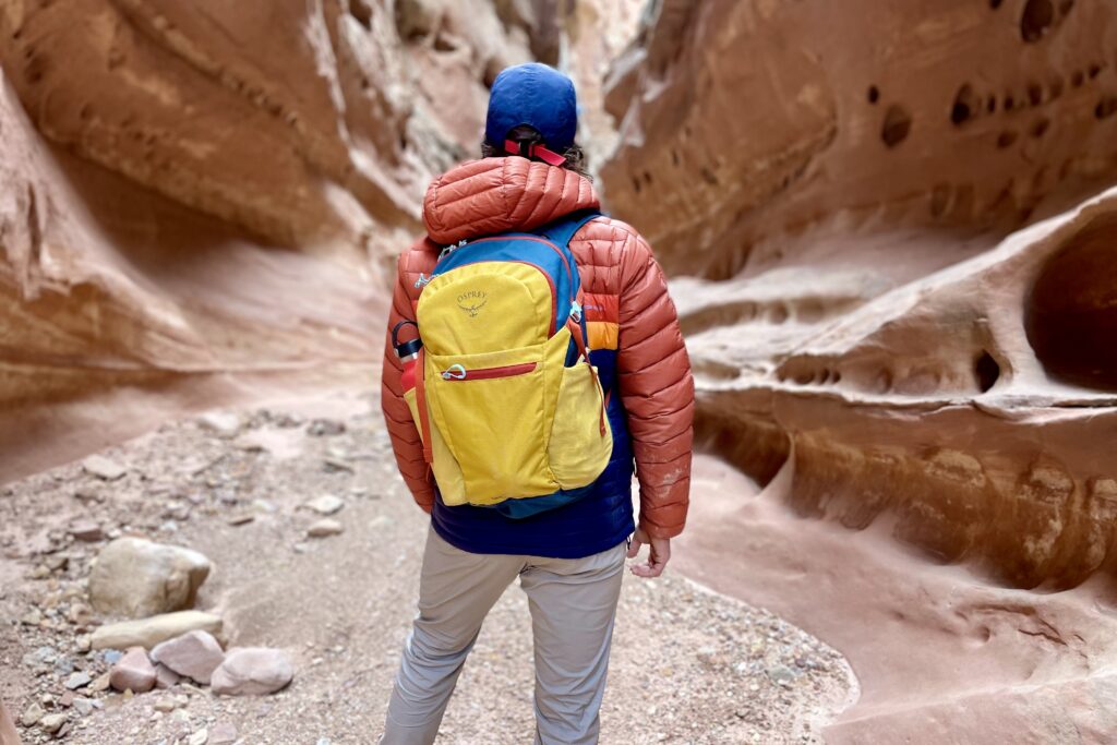 Close up of a backpack on a person's back in the desert.