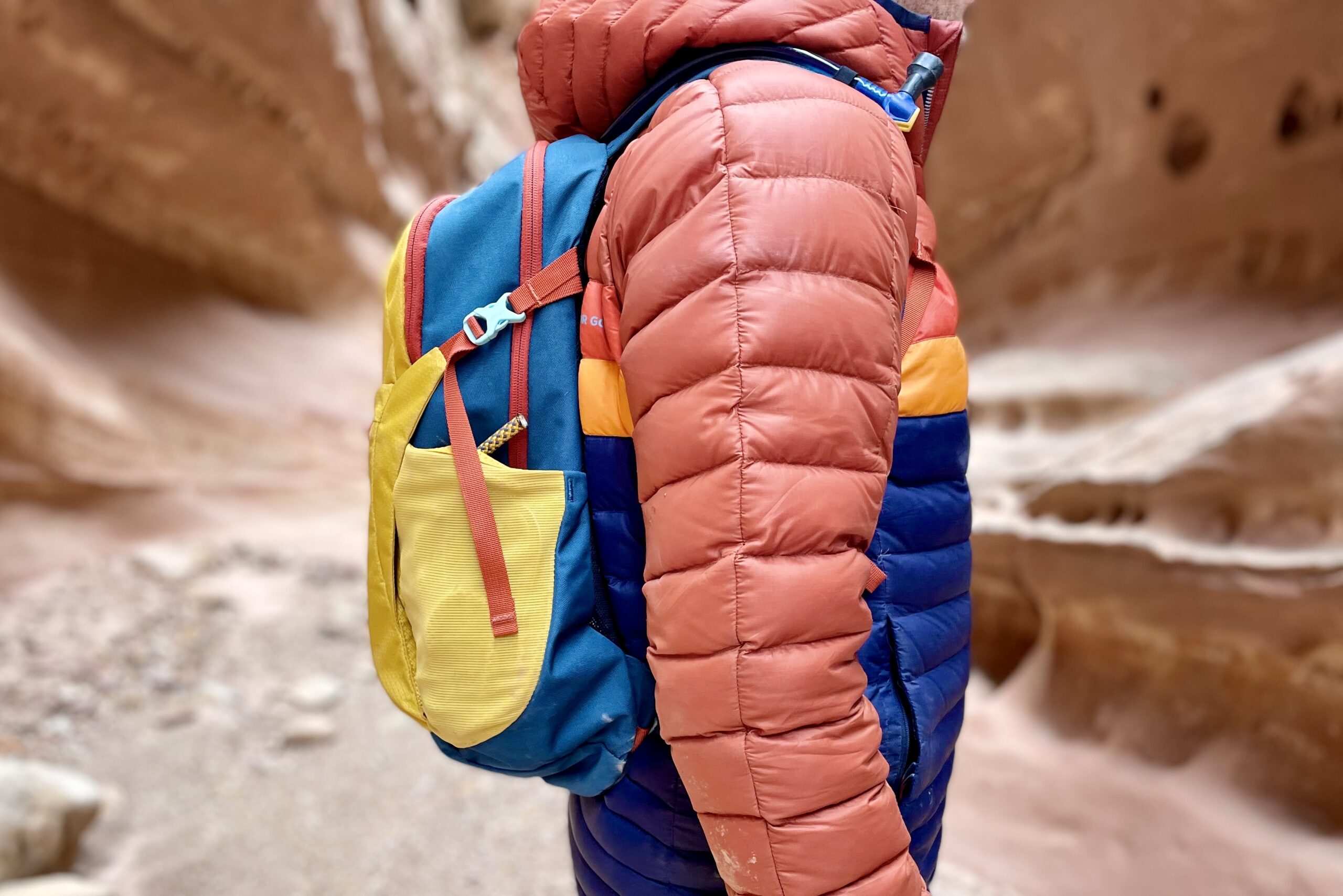 Close up of a backpack on a person's back in the desert.