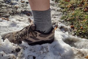 Hiker wearing the Swiftwick Pursuit in a tan hiking shoe.