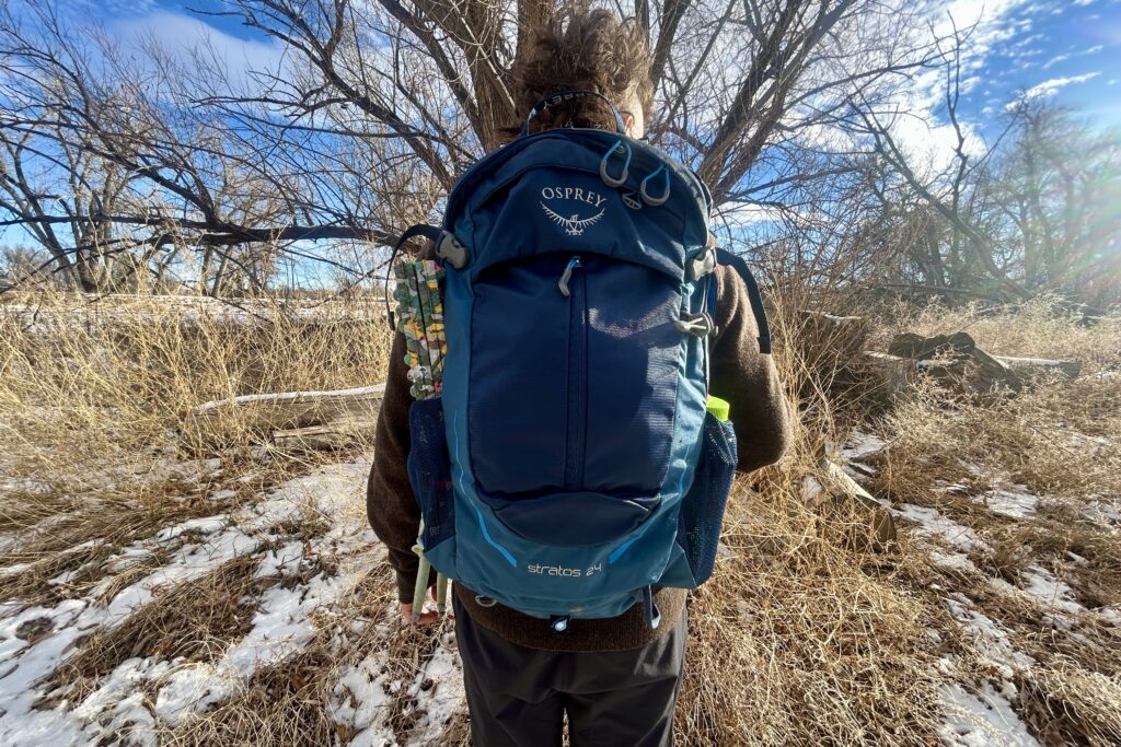 Close up of a person wearing a backpack.