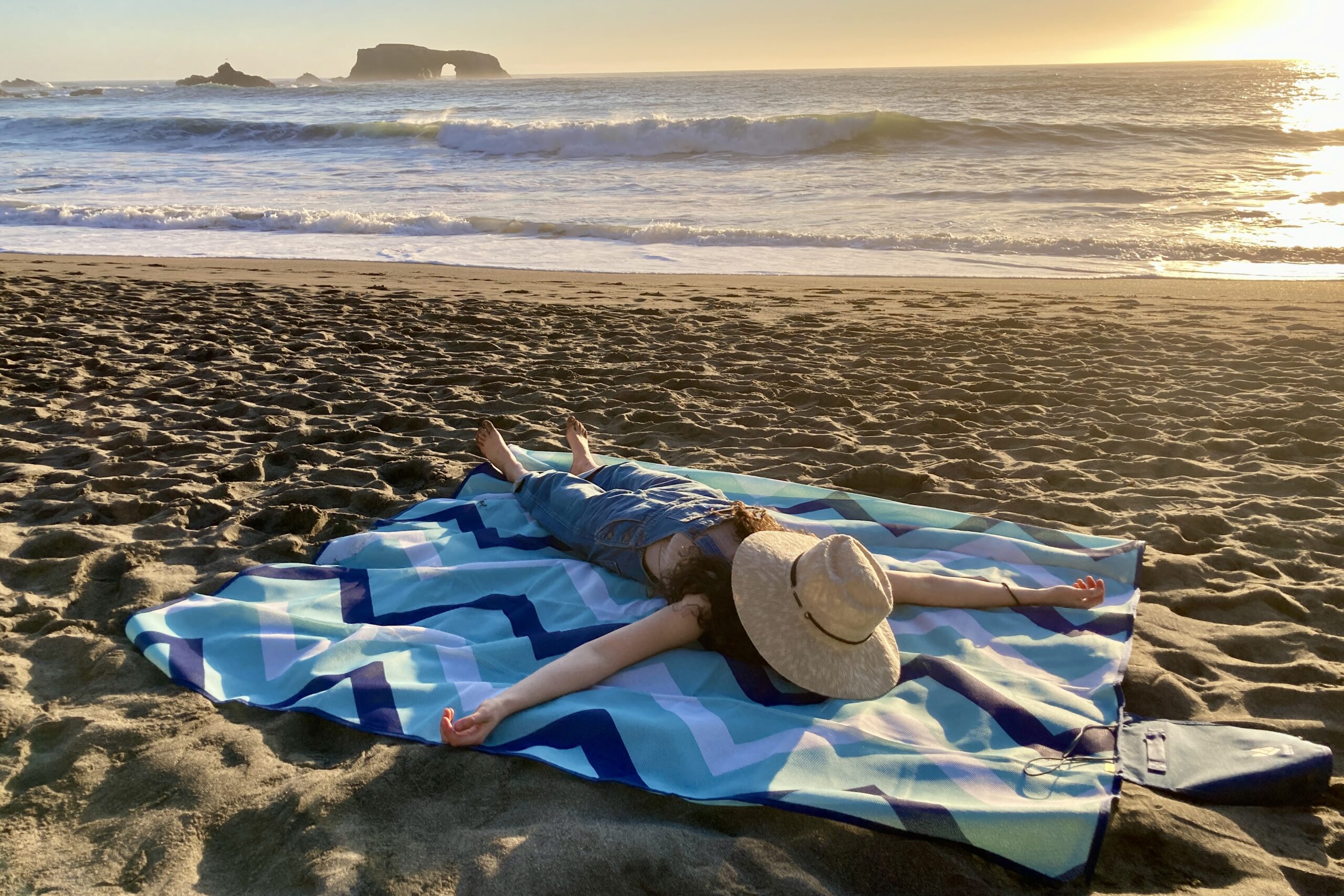 One person spread out on the CGear Multimats Sandlite Sand-free Mat at the beach.