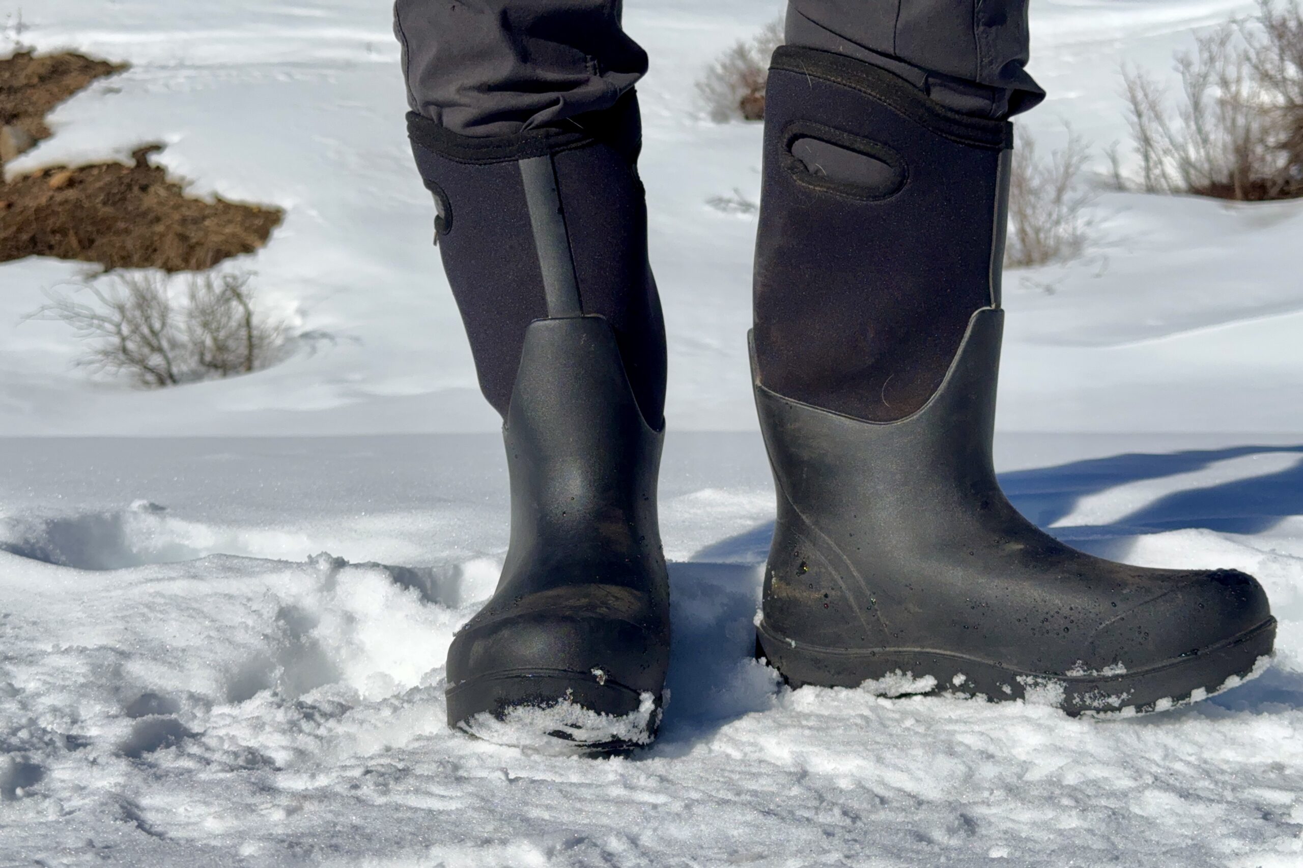 A close up of the Neo Classic Tall boots in the snow.