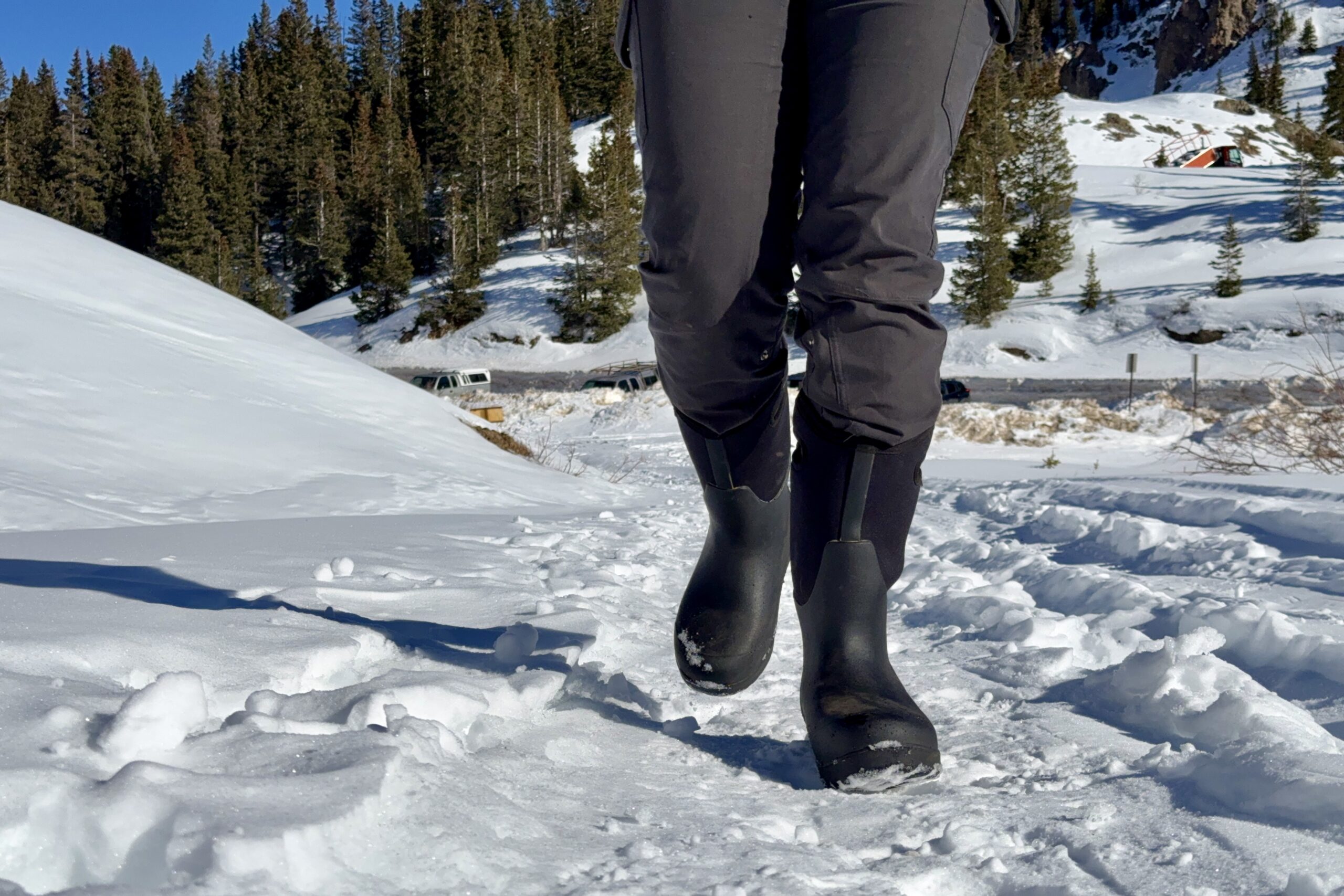 A close up of a person walking in the Neo Classic Tall boots in the snow.