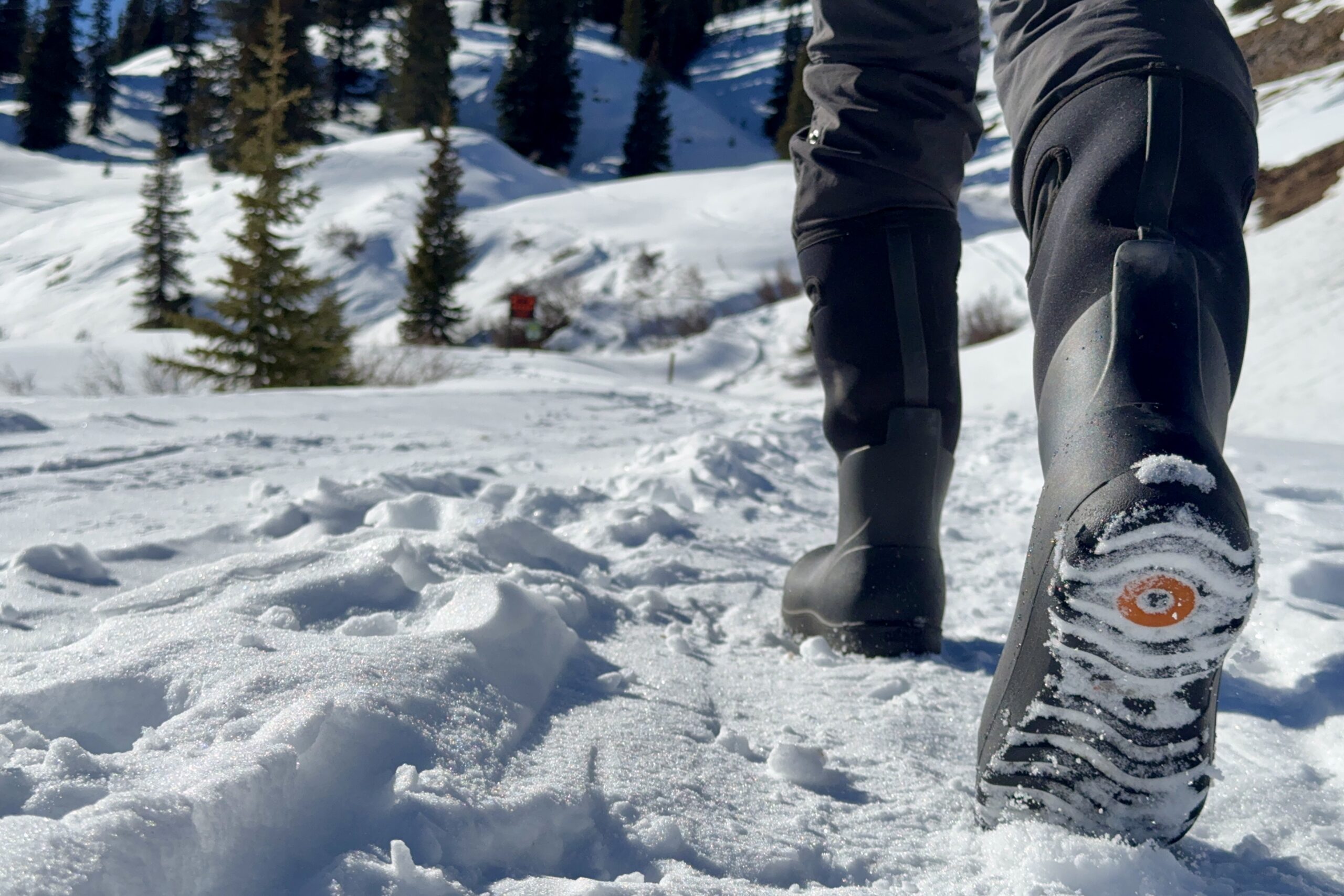 A close up of a person walking in the Neo Classic Tall boots in the snow.