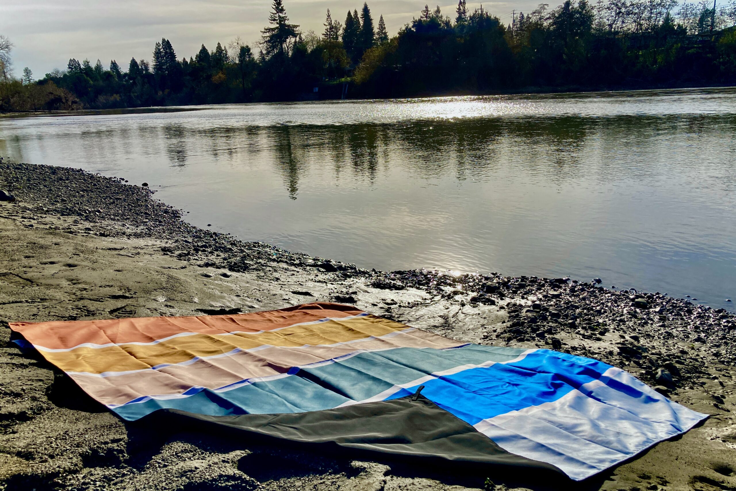 Image showing Nomadix Festival Blanket laid along along a muddy river bank.