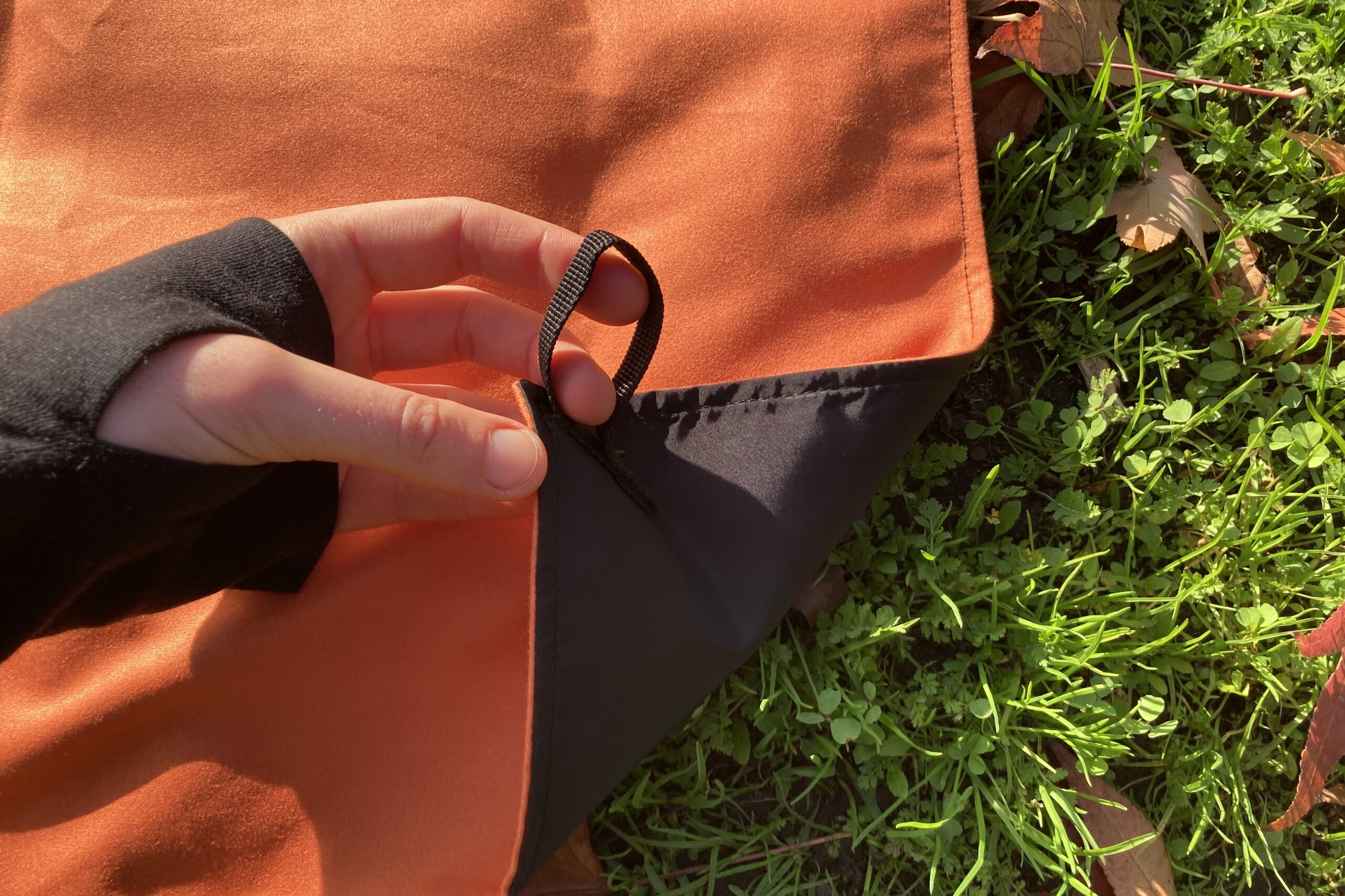 Close up showing the corner loops on the Nomadix Festival Blanket