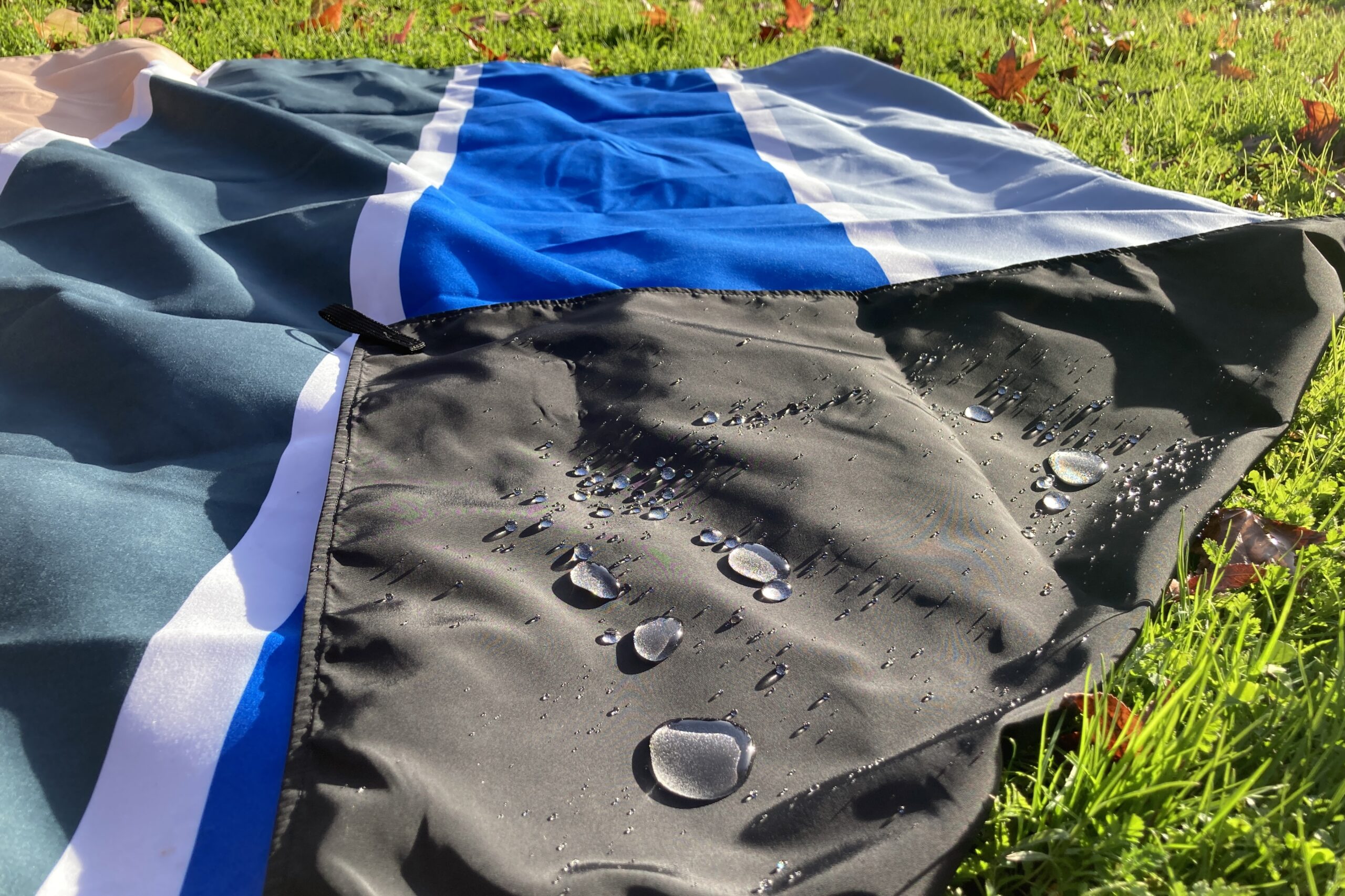 Close up showing water beading on the bottom layer of the Nomadix Festival Blanket