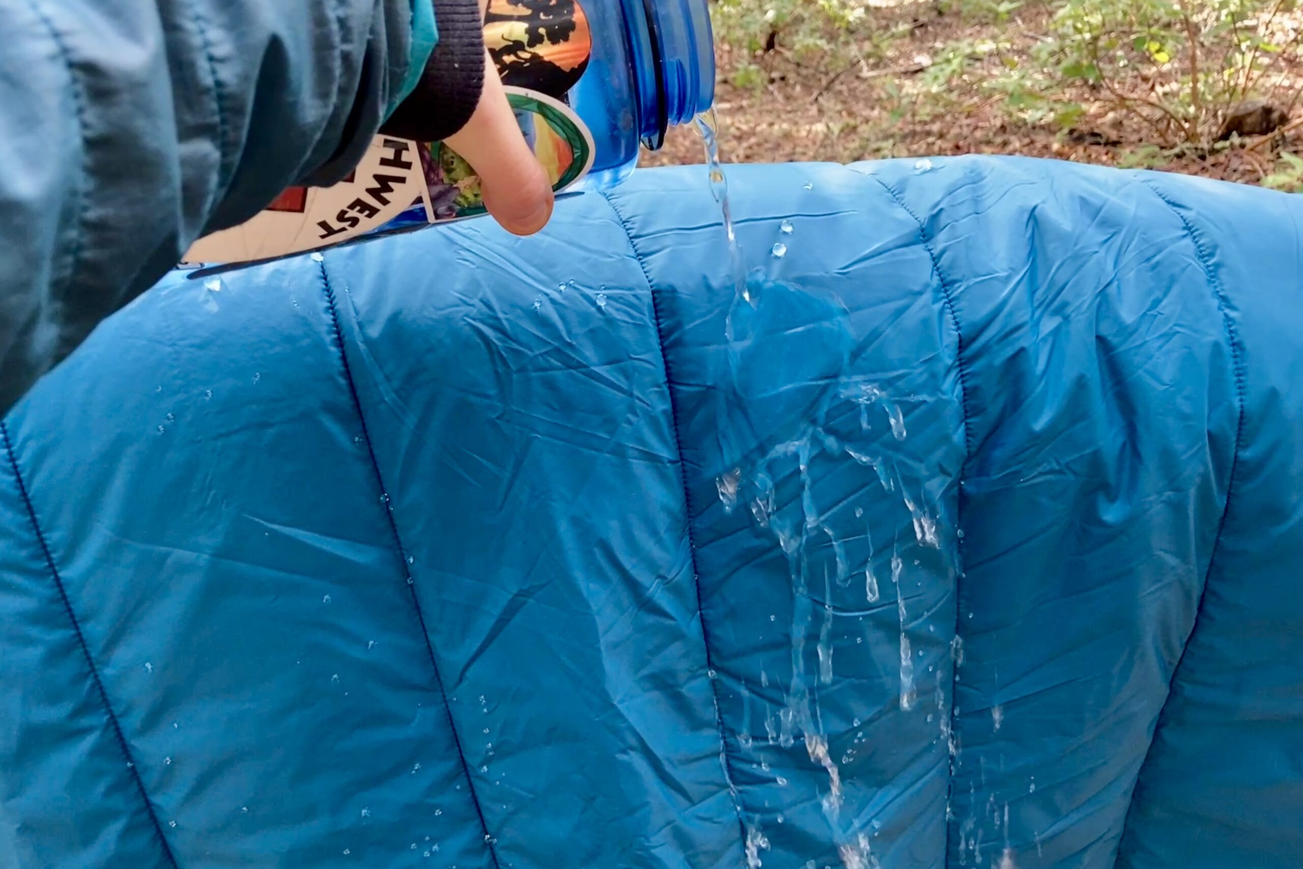 Pouring water over the REI camp blanket and it beads easily off the material