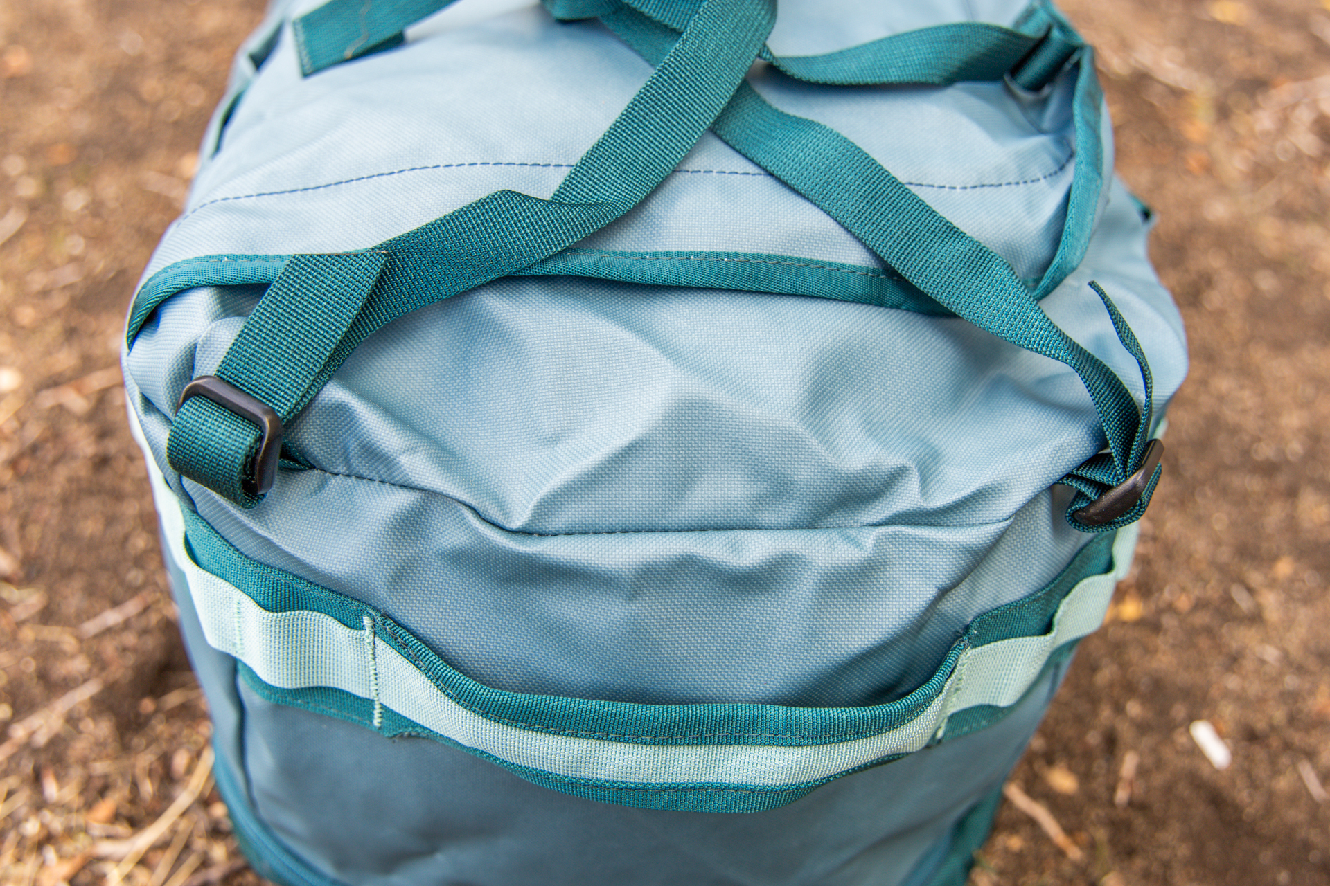 A detail shot of the webbing straps that connect the pack straps on one end of the Cotopaxi Allpa 50L duffel.