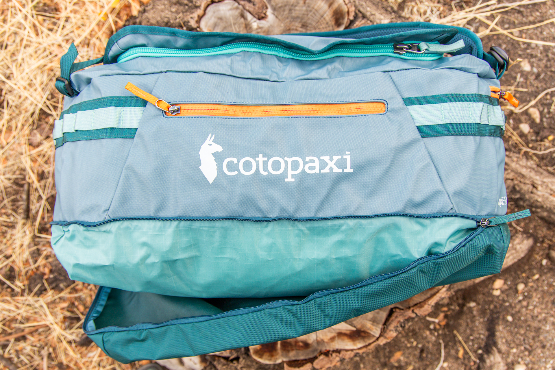 The bottom zipper compartment half open on the Cotopaxi Allpa 50L.