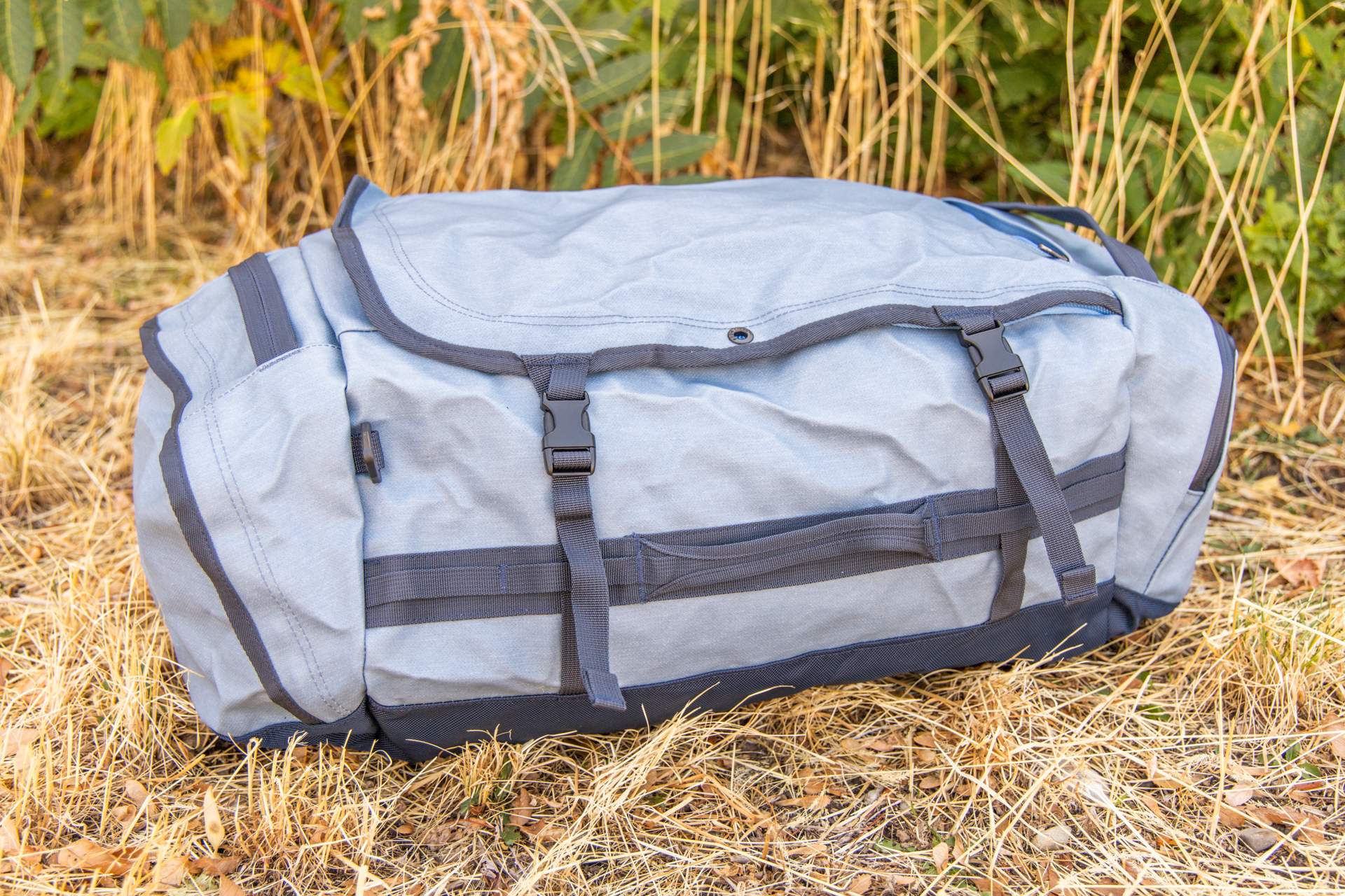 One long side of the Eagle Creek Cargo Hauler 60L duffel showing compression straps and no pockets.