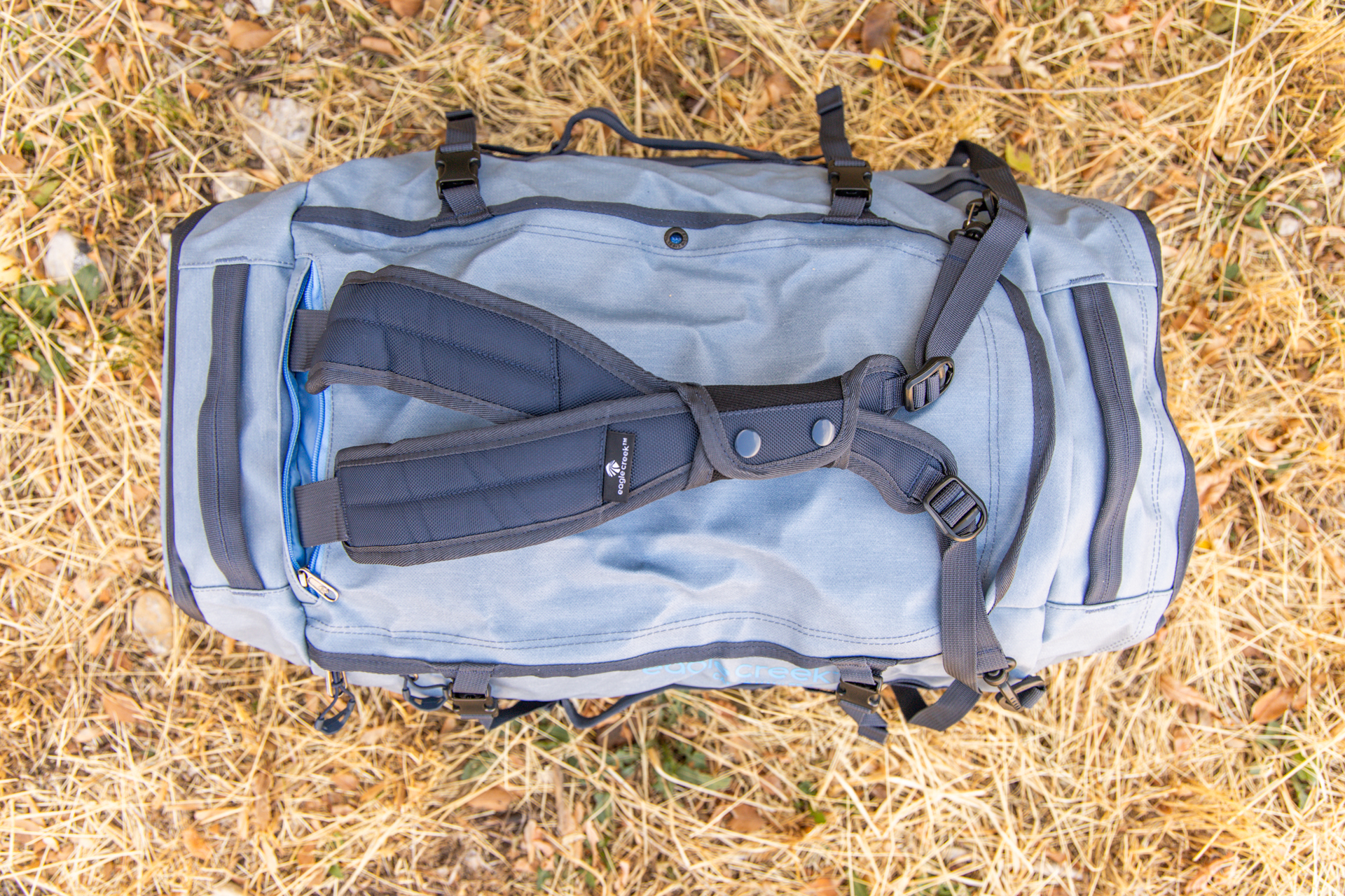 The stowable backpack straps clipped together for one-handed carry on the Eagle Creek Cargo Hauler 60L duffel.