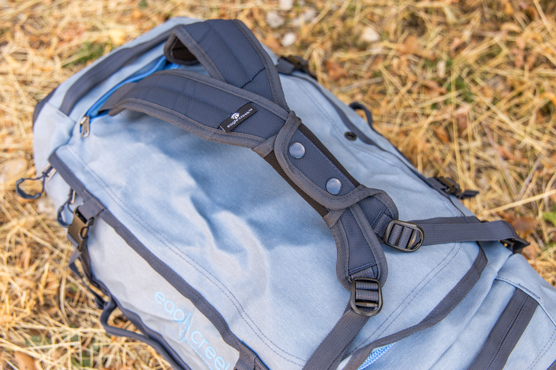 The stowable backpack straps clipped together for one-handed carry on the Eagle Creek Cargo Hauler 60L duffel.