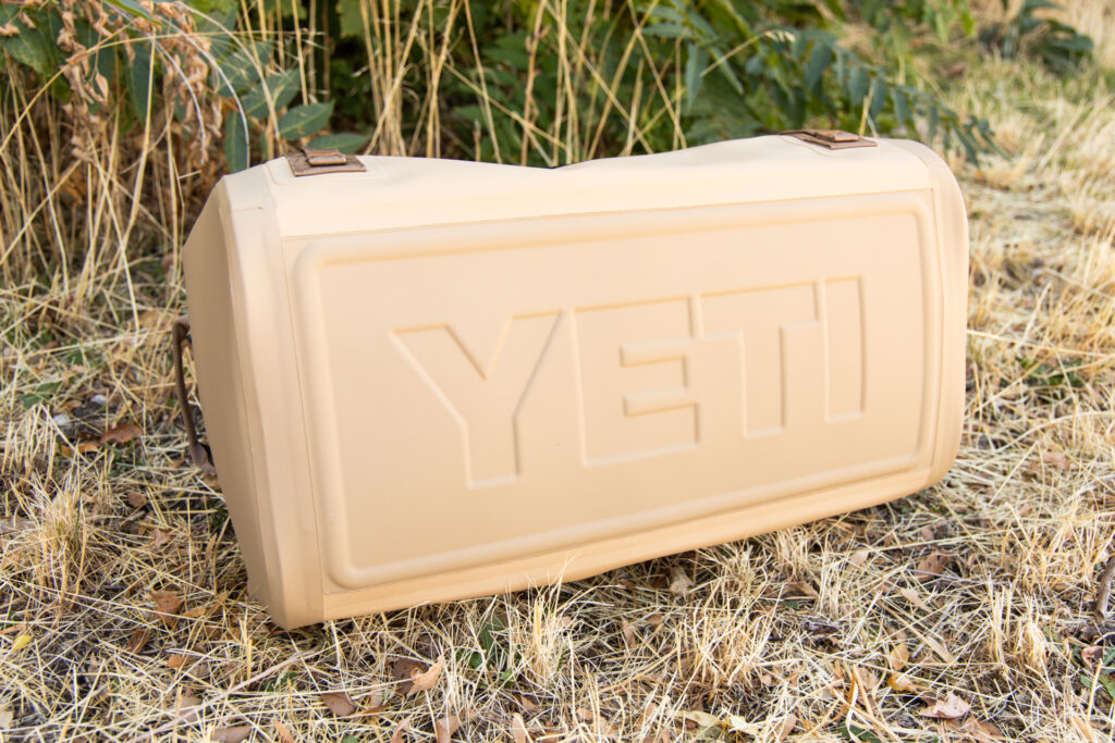 The bottom of the duffel with the name "Yeti" embossed in the durable base.