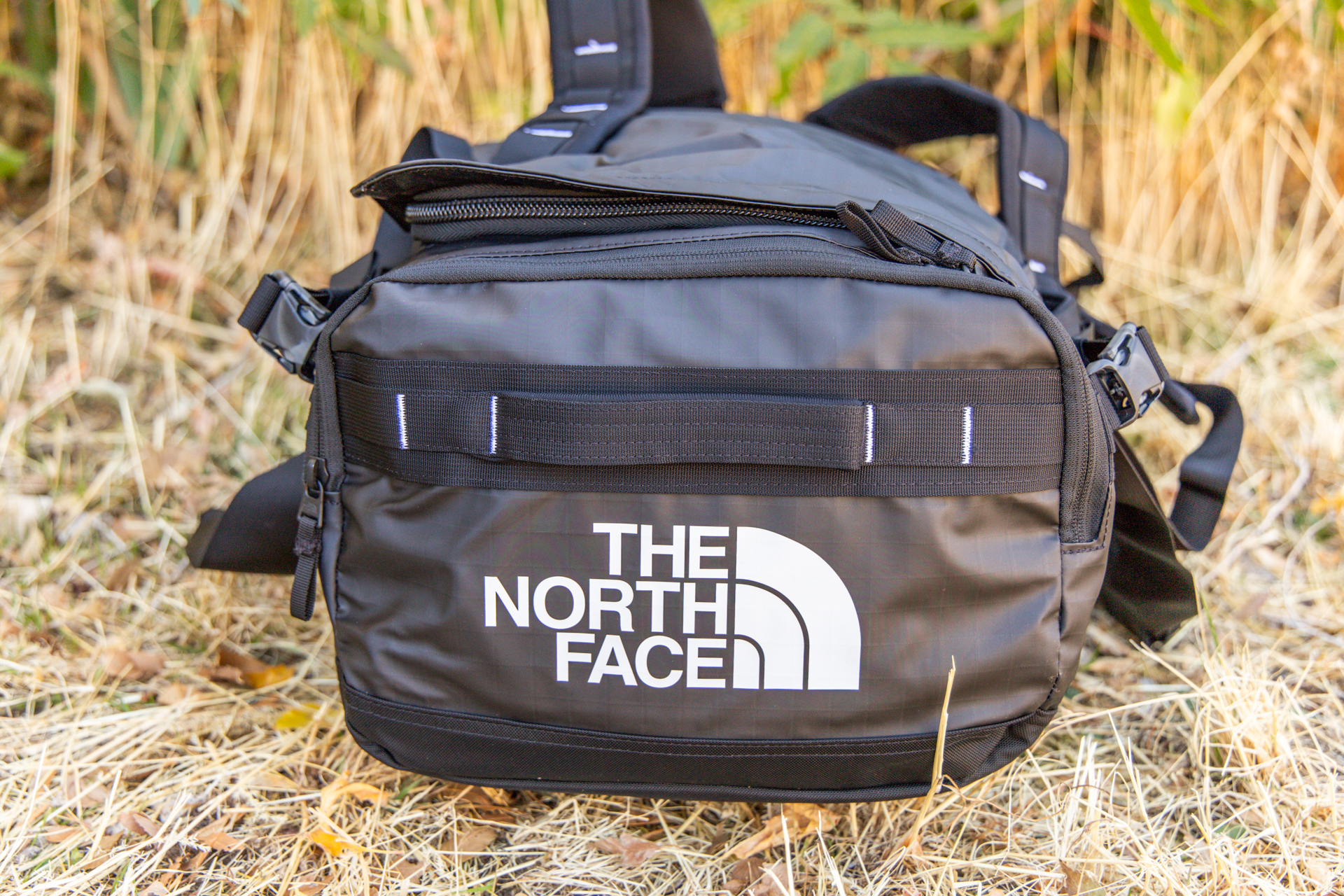 The North Face Base Camp Voyager duffel as viewed from the end, showing a grab handle and exterior pocket.