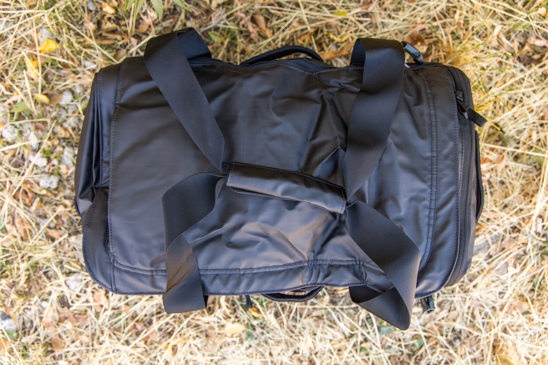 A top down view of the duffel with duffel straps lashed together with a Velcro wrap.