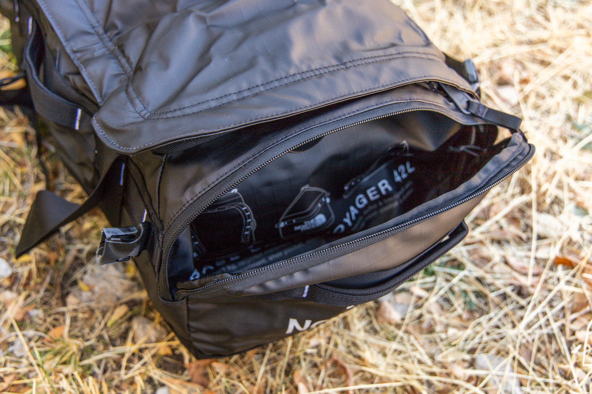 The spacious pocket on one end of the bag unzipped; its the same pocket used to pack the duffel up when not in use.