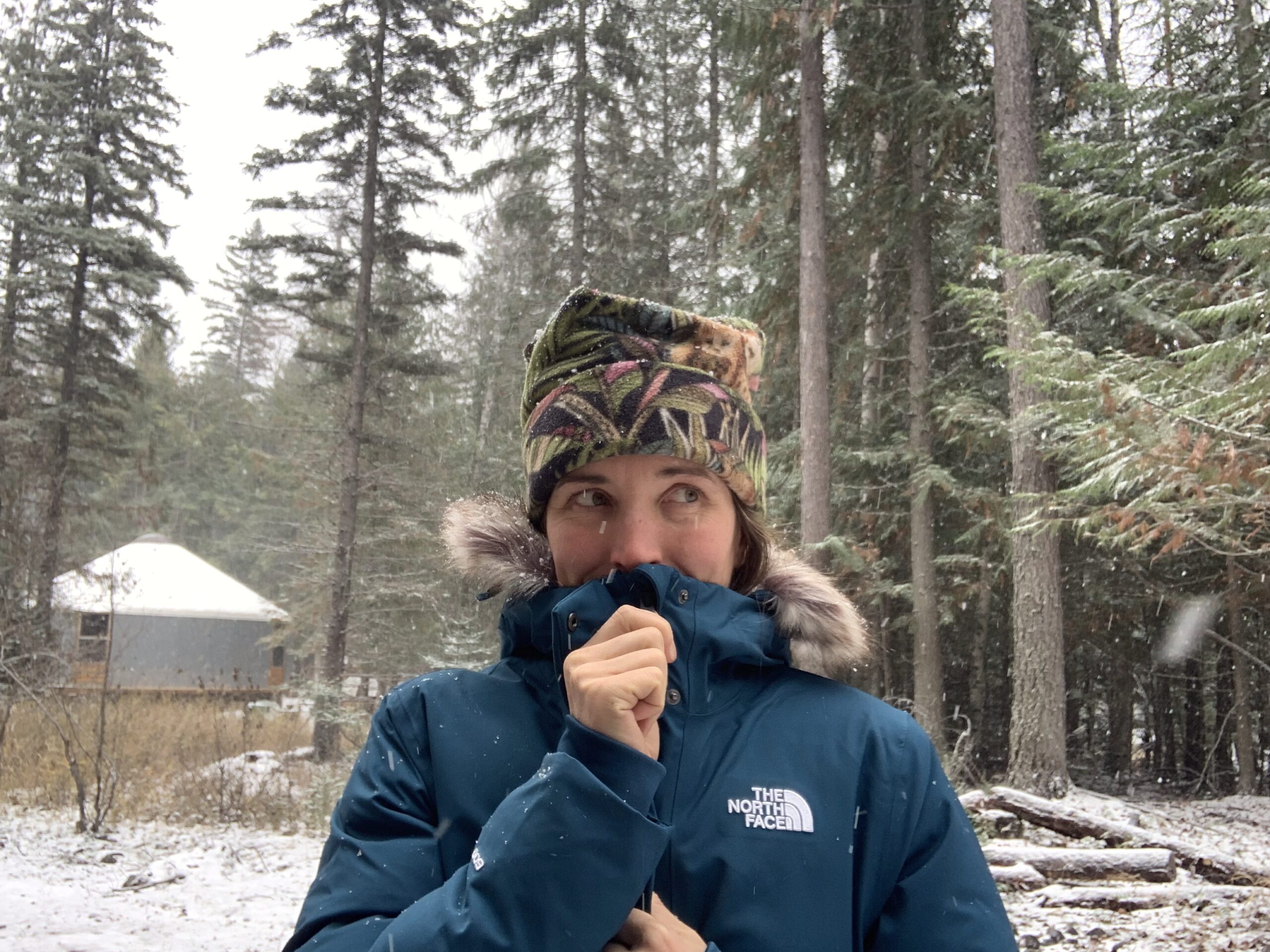 a close up of zipping up the collar of the north face arctic parka