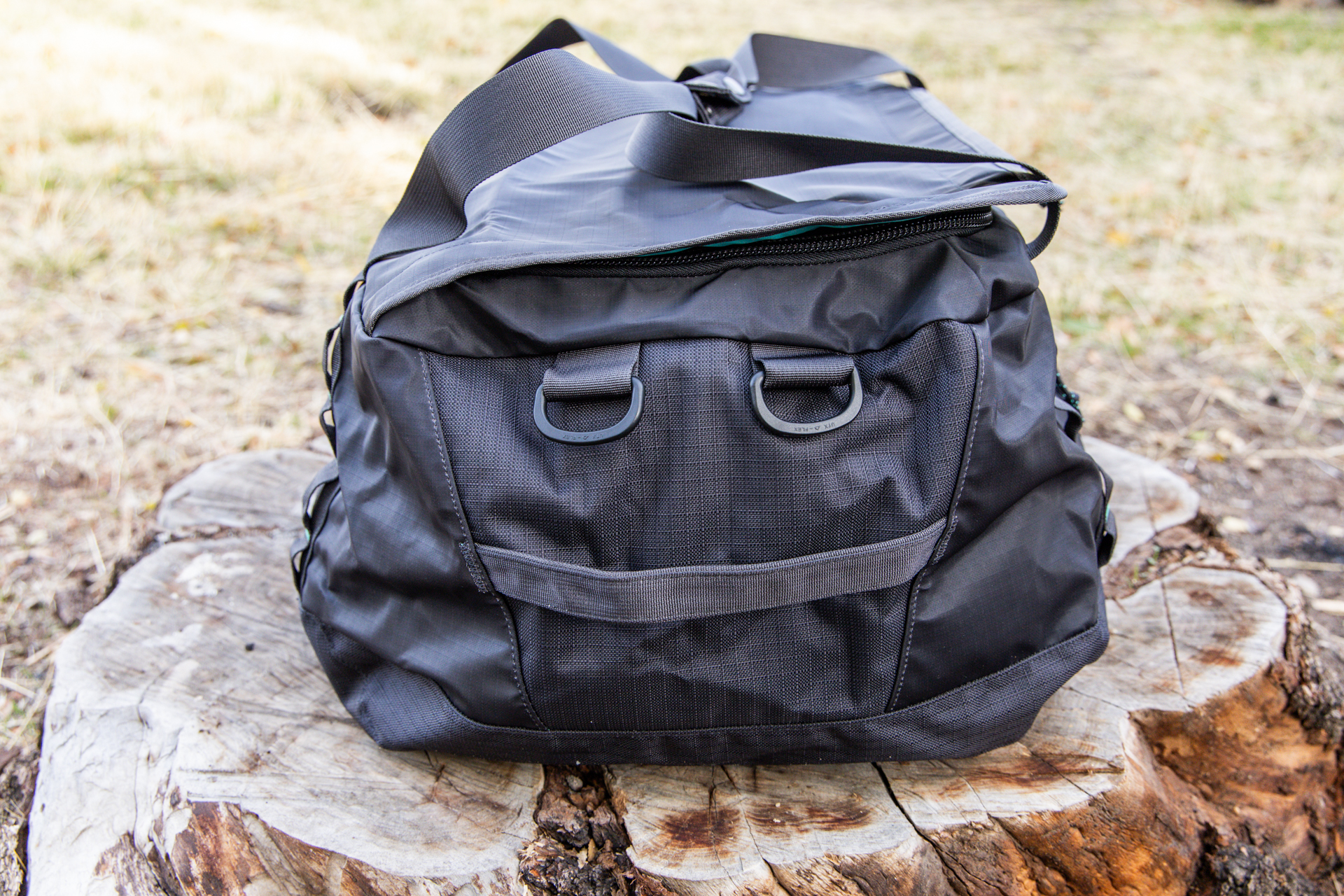 An end view of the duffel bag featuring a sturdy grab handle.