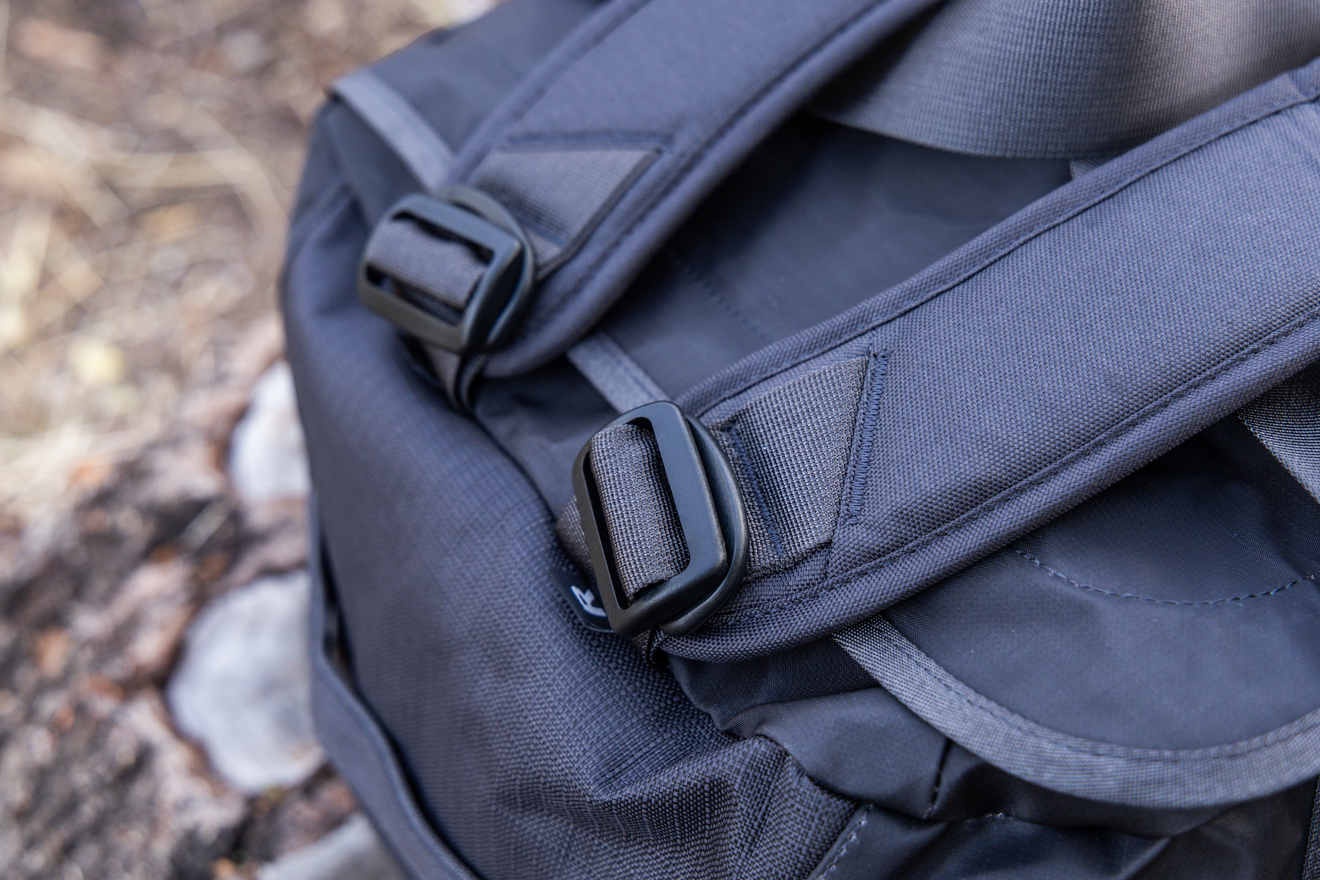 A close up shot of the D-rings and toggles used to attach the pack straps to the top of the bag.