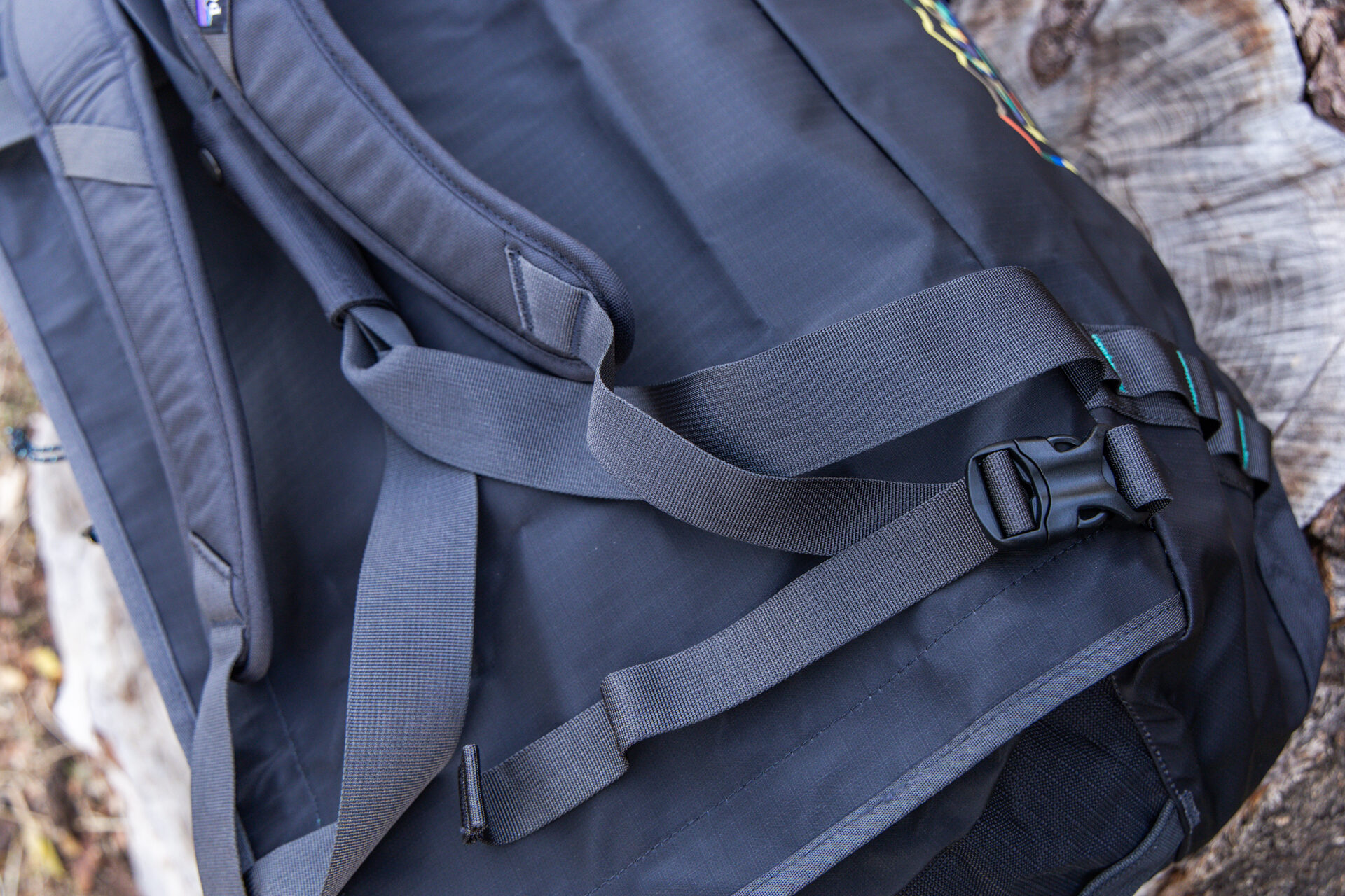 A close up shot of the buckle clips used to attach the pack straps to the bottom of the bag.