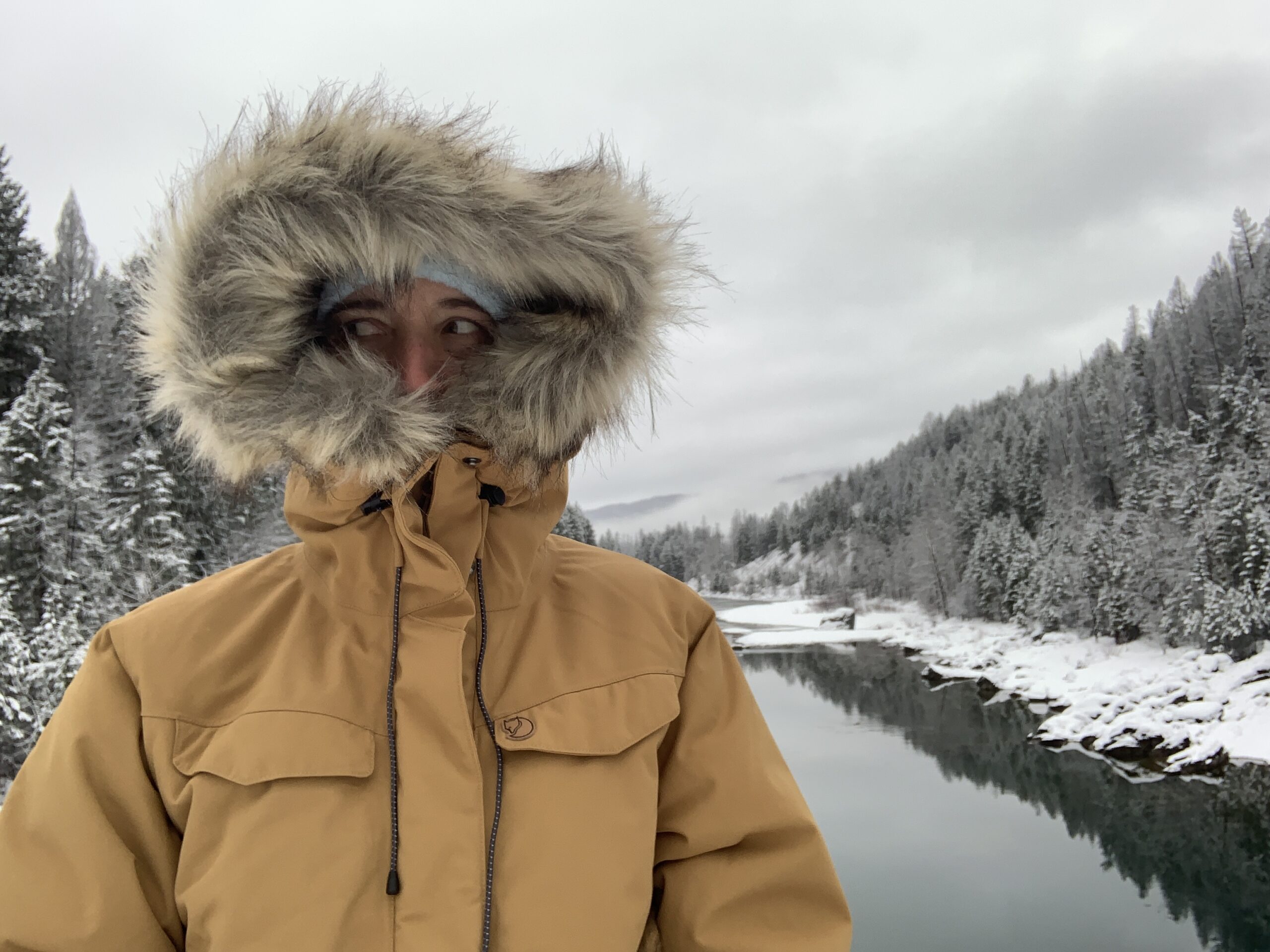 the hood of the fjallraven nuuk winter parka cinched down over a person's face showing very little expose skin