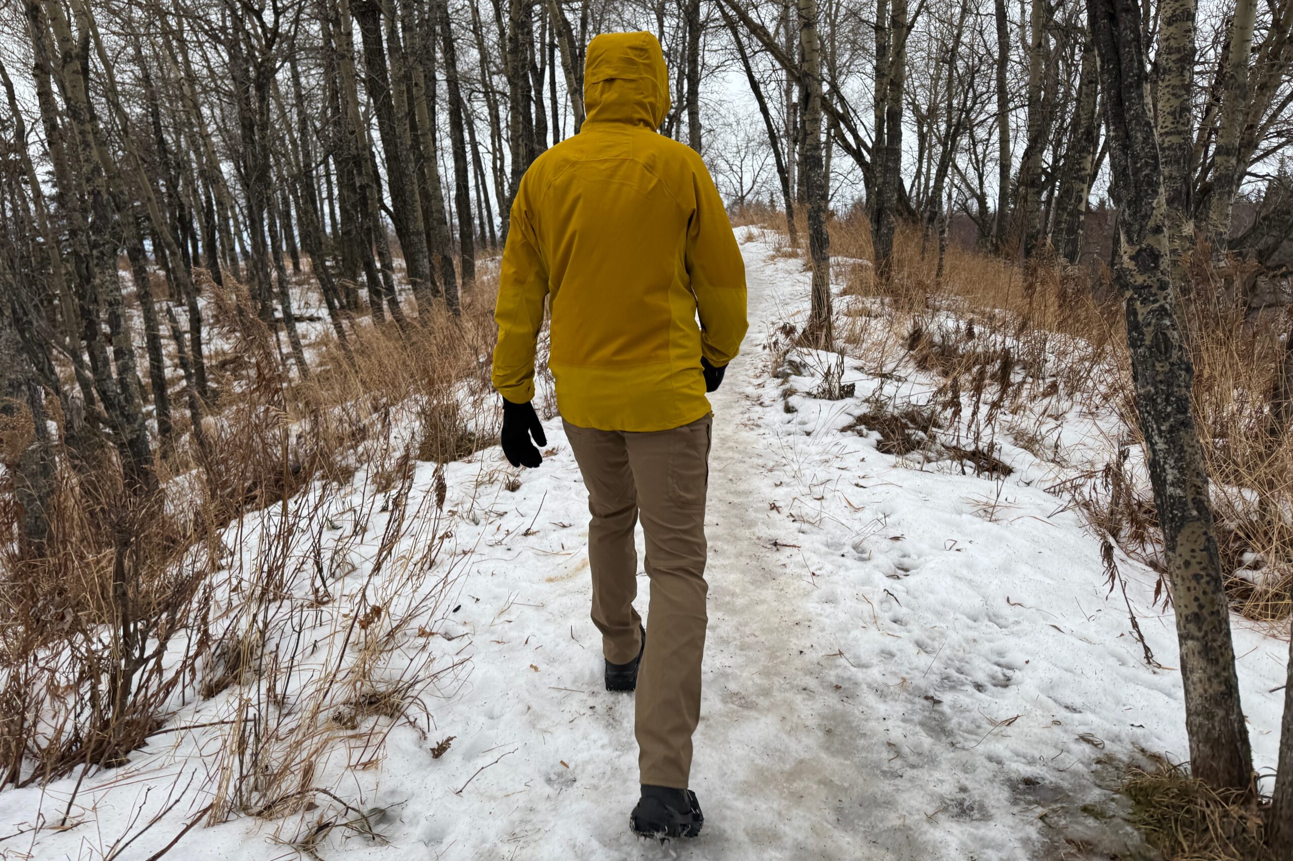 A view of the back of a yellow rain jacket.