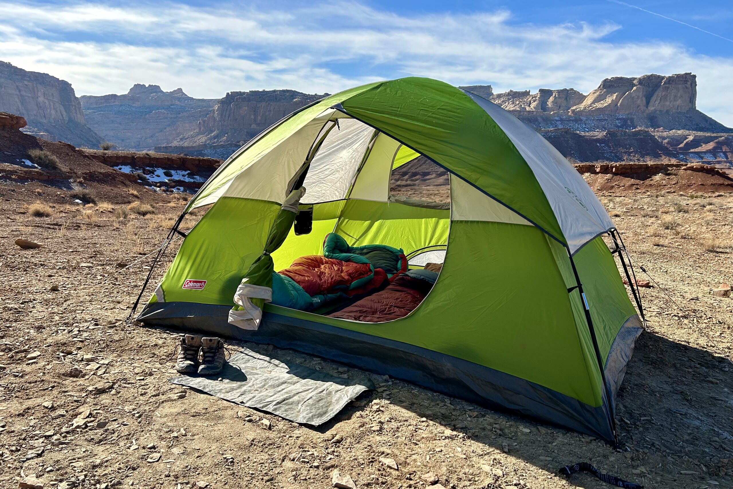 A tent setup in the desert under a blue sky.