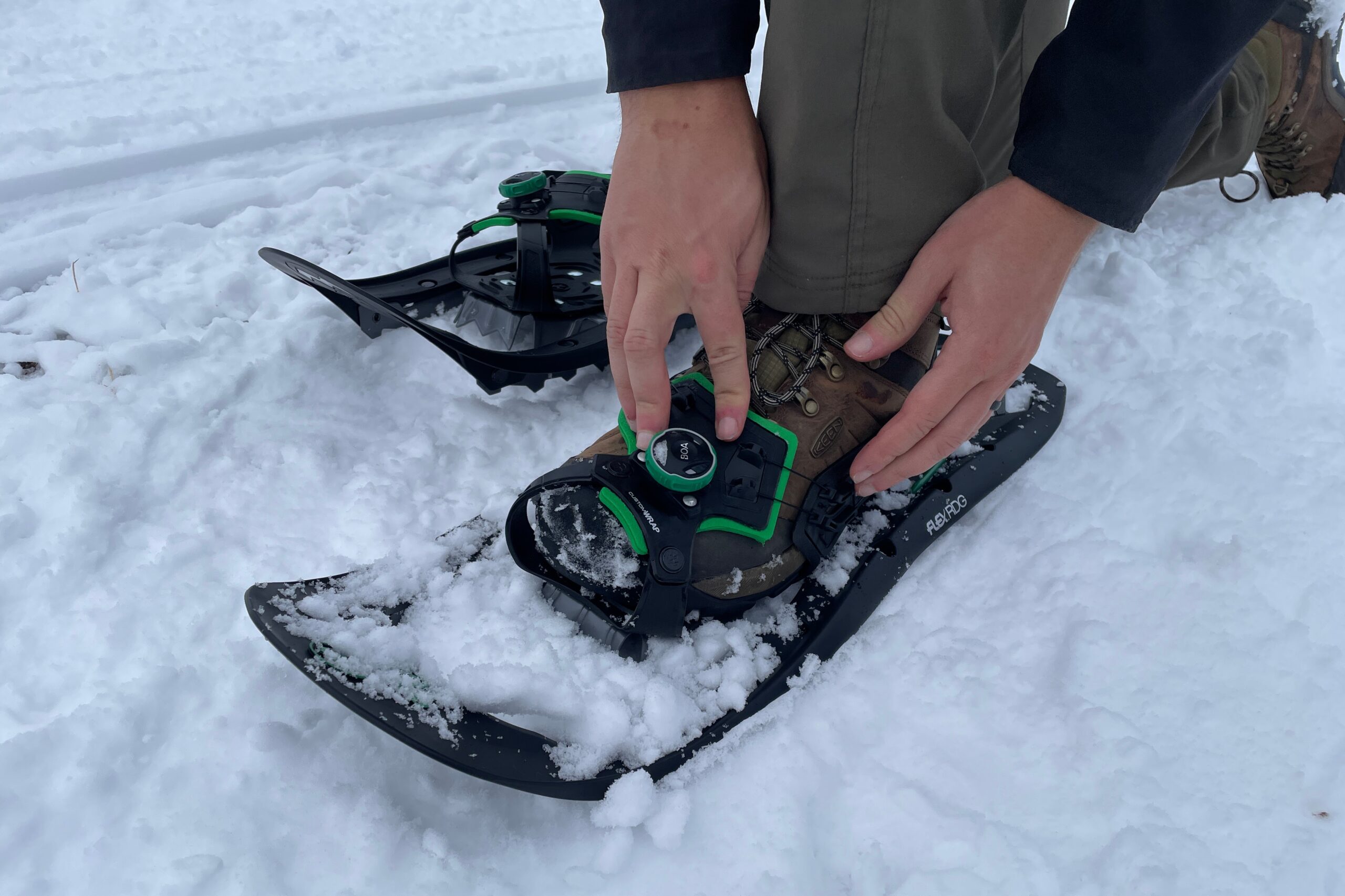 The tope of a pair of snowshoes showing their binding.