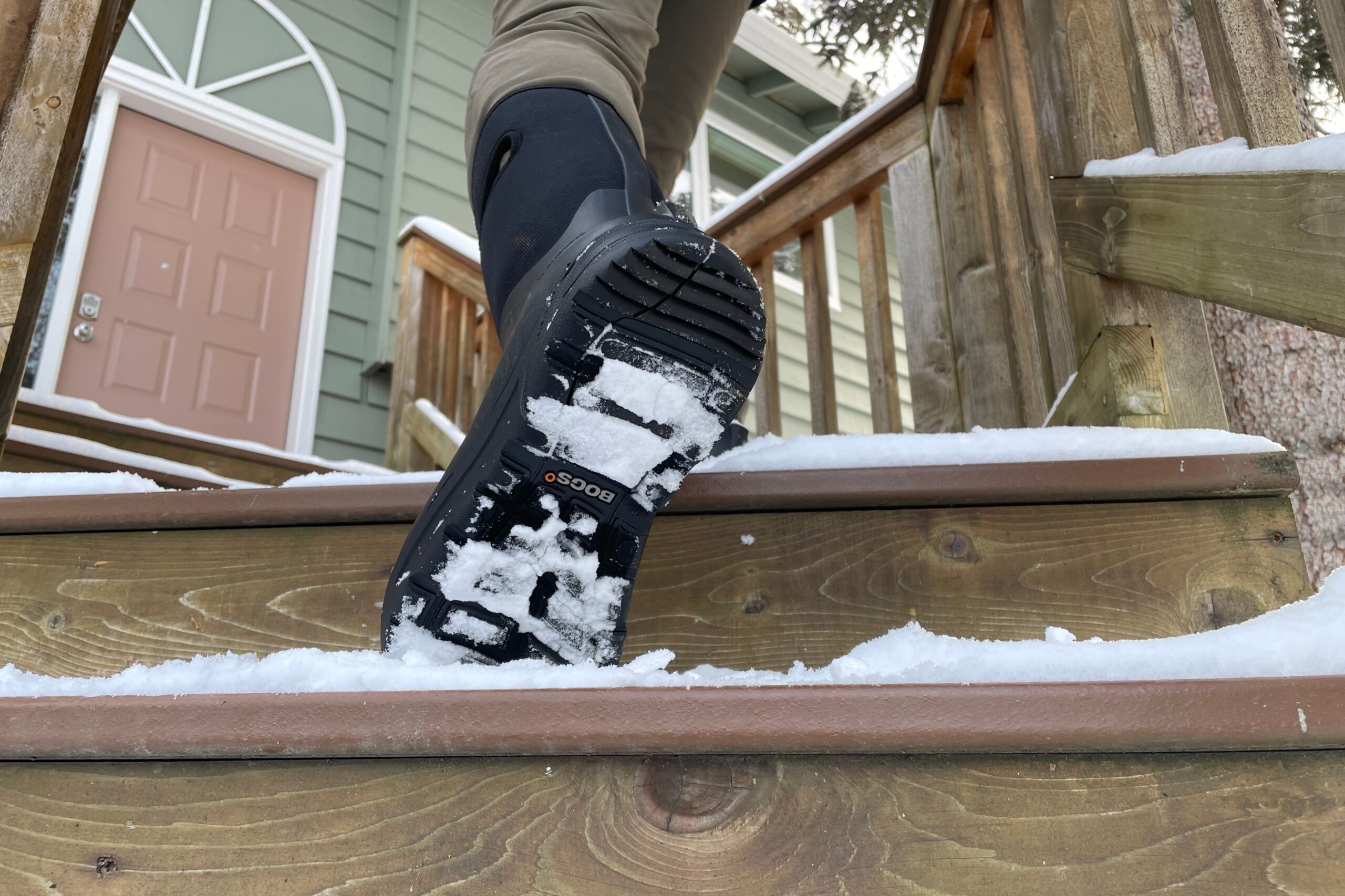 A closeup of the trad of boots walking up steps.