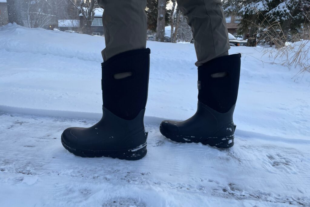 Closeup of boots walking down a snowy driveway