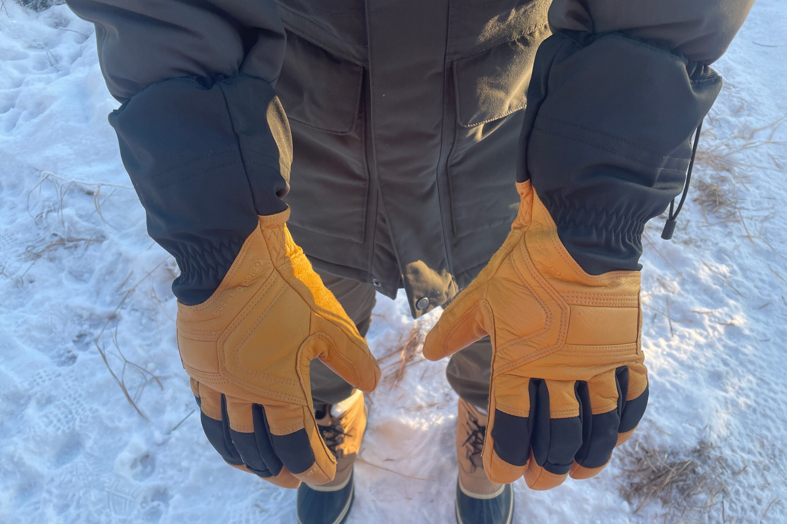 A man shows the back of the hands of his gloves