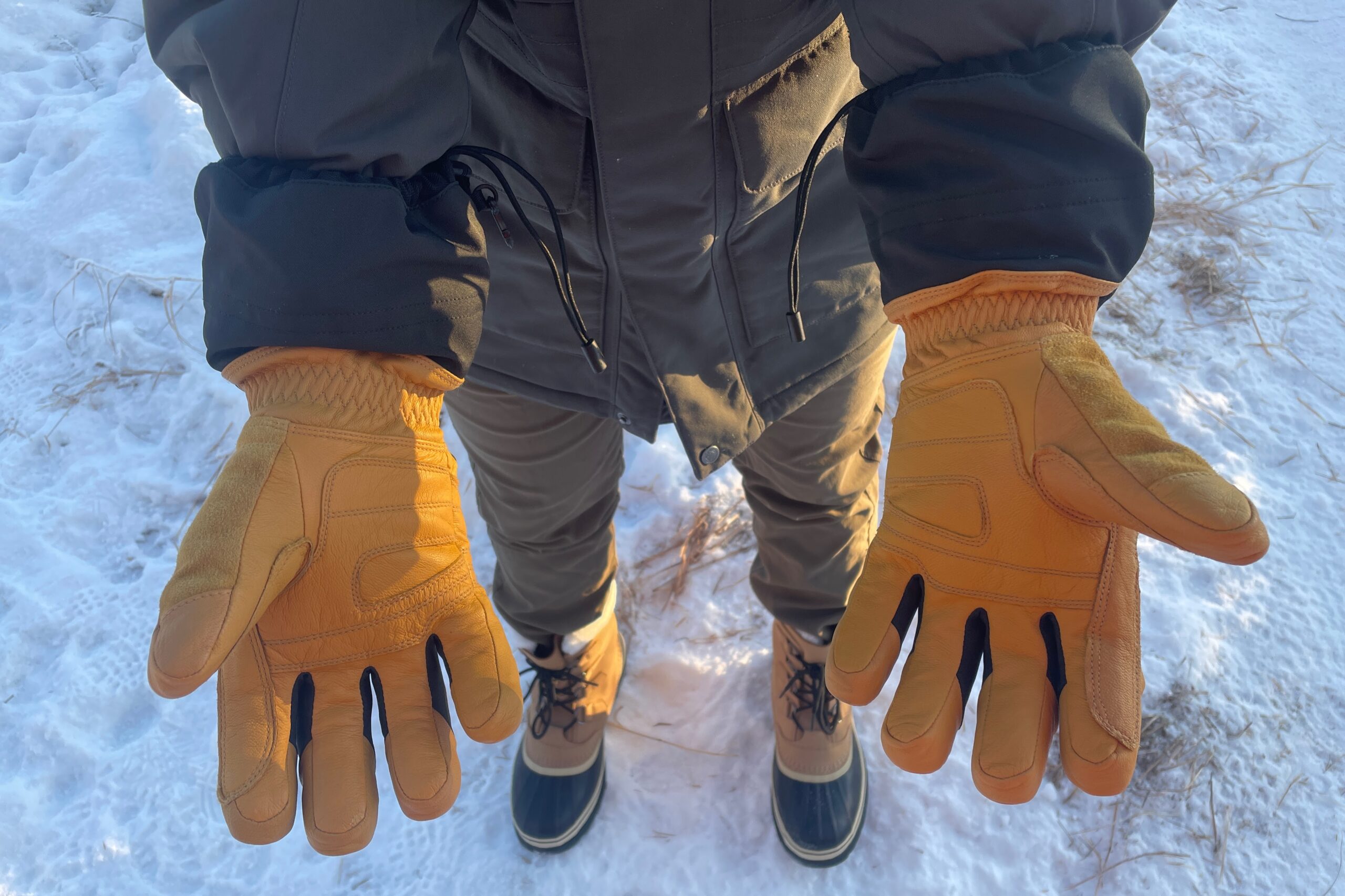 A man shows the palms of his gloves.