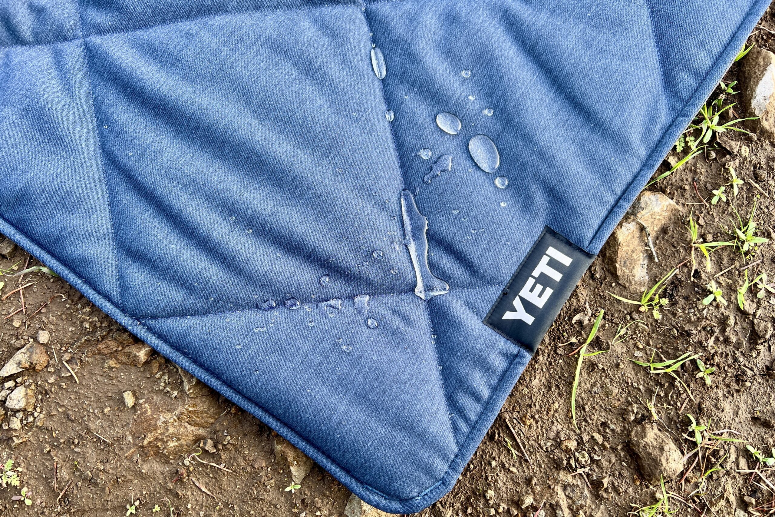 Water beads on the top insulated layer of the Yeti Lowlands Blanket